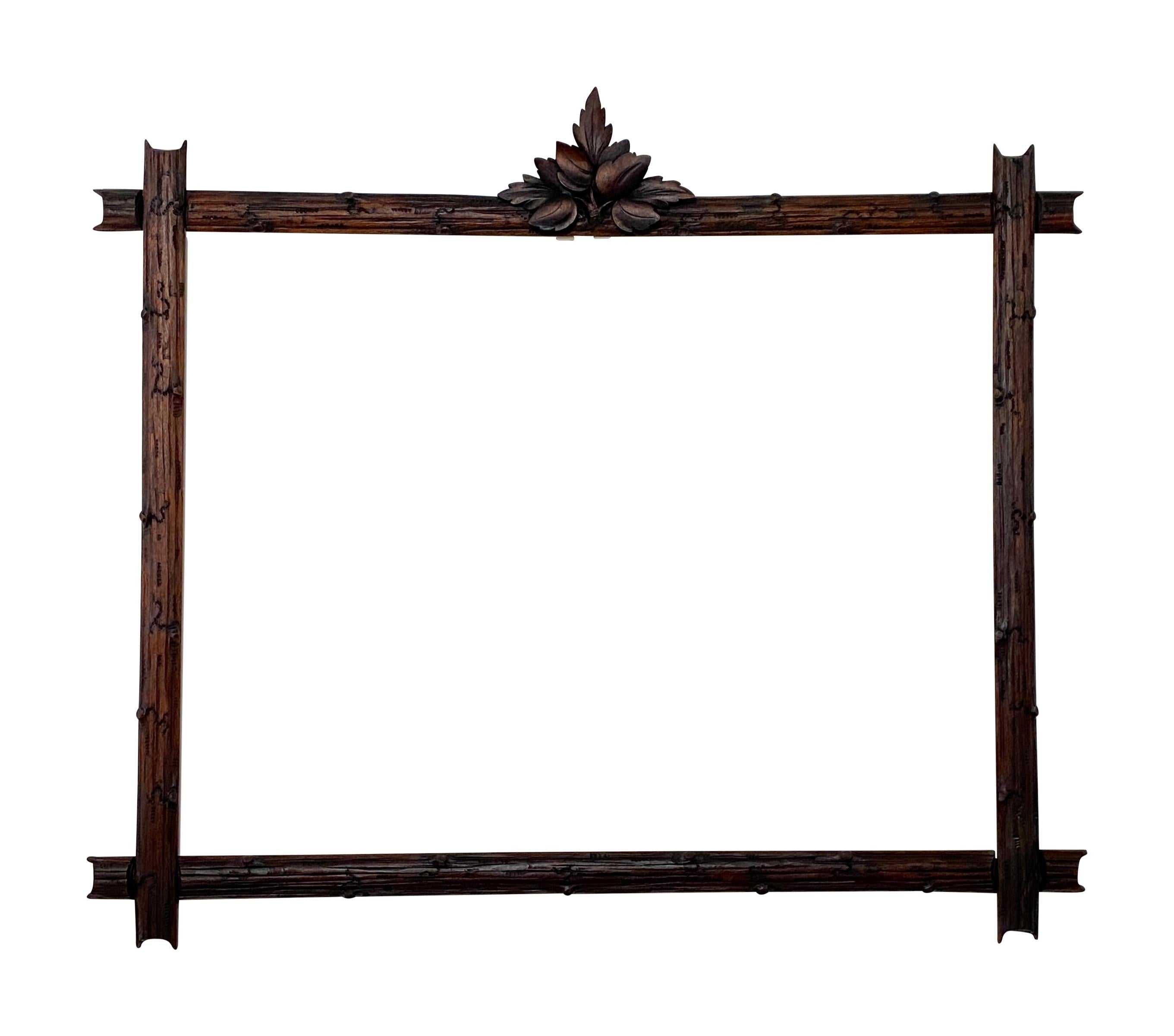  
A large 19th century hand carved solid walnut Black Forest style picture frame with traditional tree limb and foliage detail. 
Inner sight of the frames measures 27