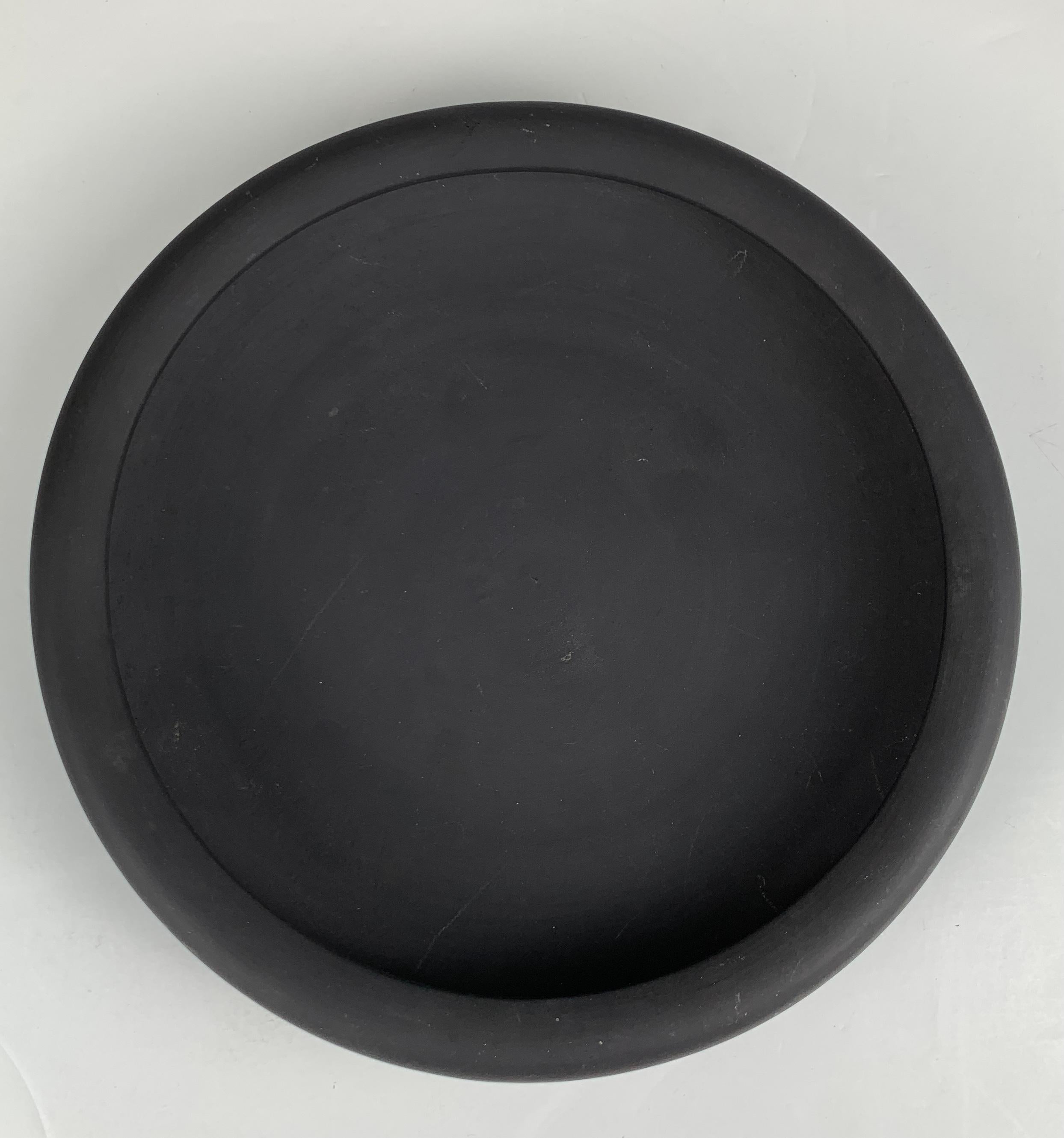 This large and beautiful Wedgwood Black Basalt bowl is a masterpiece of 19th-century stoneware.
Its elegant rolled edge and simple inverted lip give it a refined and sophisticated appearance. 
The bowl is made from Black Basalt stoneware, a material