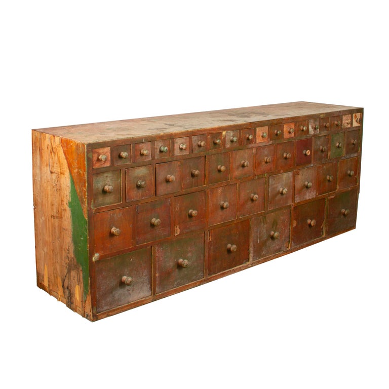 Impressive 19th century Swedish apothecary cabinet. This apothecary cabinet is in its original condition. It has great colour and patina, with remains of the original paintwork. It has come directly from a Swedish pharmacy where it would have been