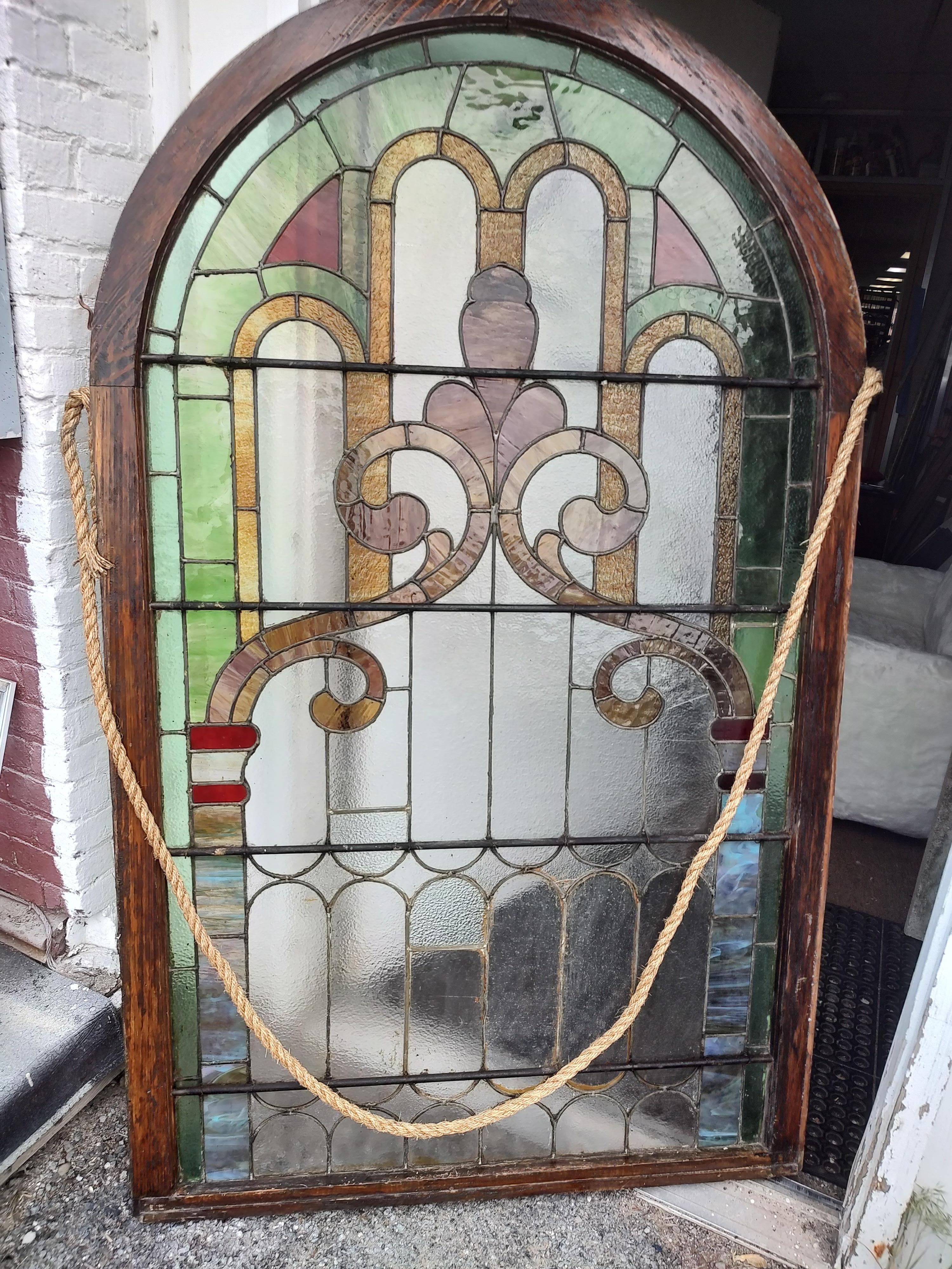 Large and fabulous arch top leaded and stained glass windows in oak frames. 74 x 45 and in excellent antique condition. Some cracks but nothing structural. One window was used as a door so it is a little bigger, a panel was added to the base. This