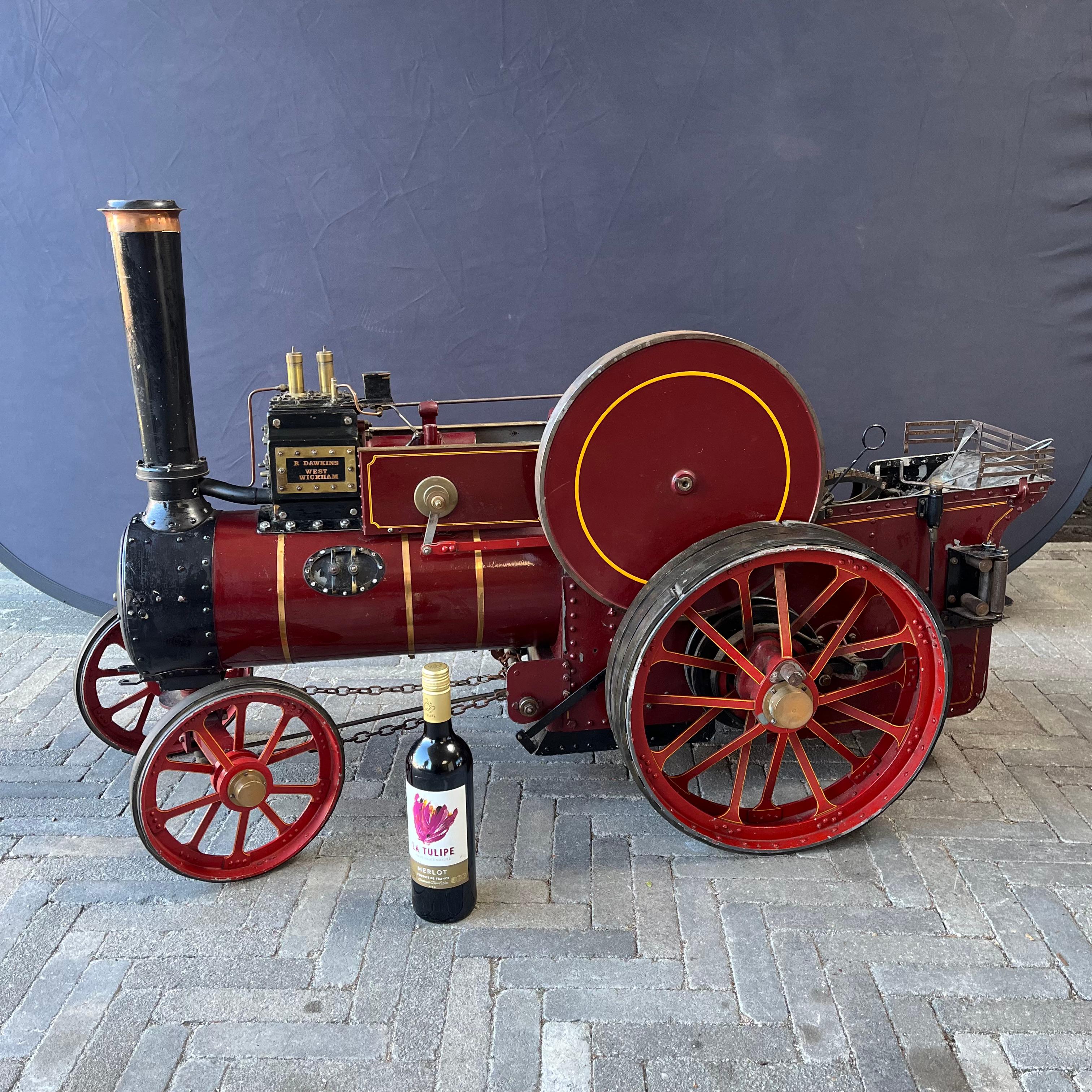 A large live steam 2” scale model traction engine steam tractor in red livery and brass coat of arms. Produced by Dawkins West Wickham.

The tractor exudes real craftsmanship and is very well made down to the smallest details. 
The 2
