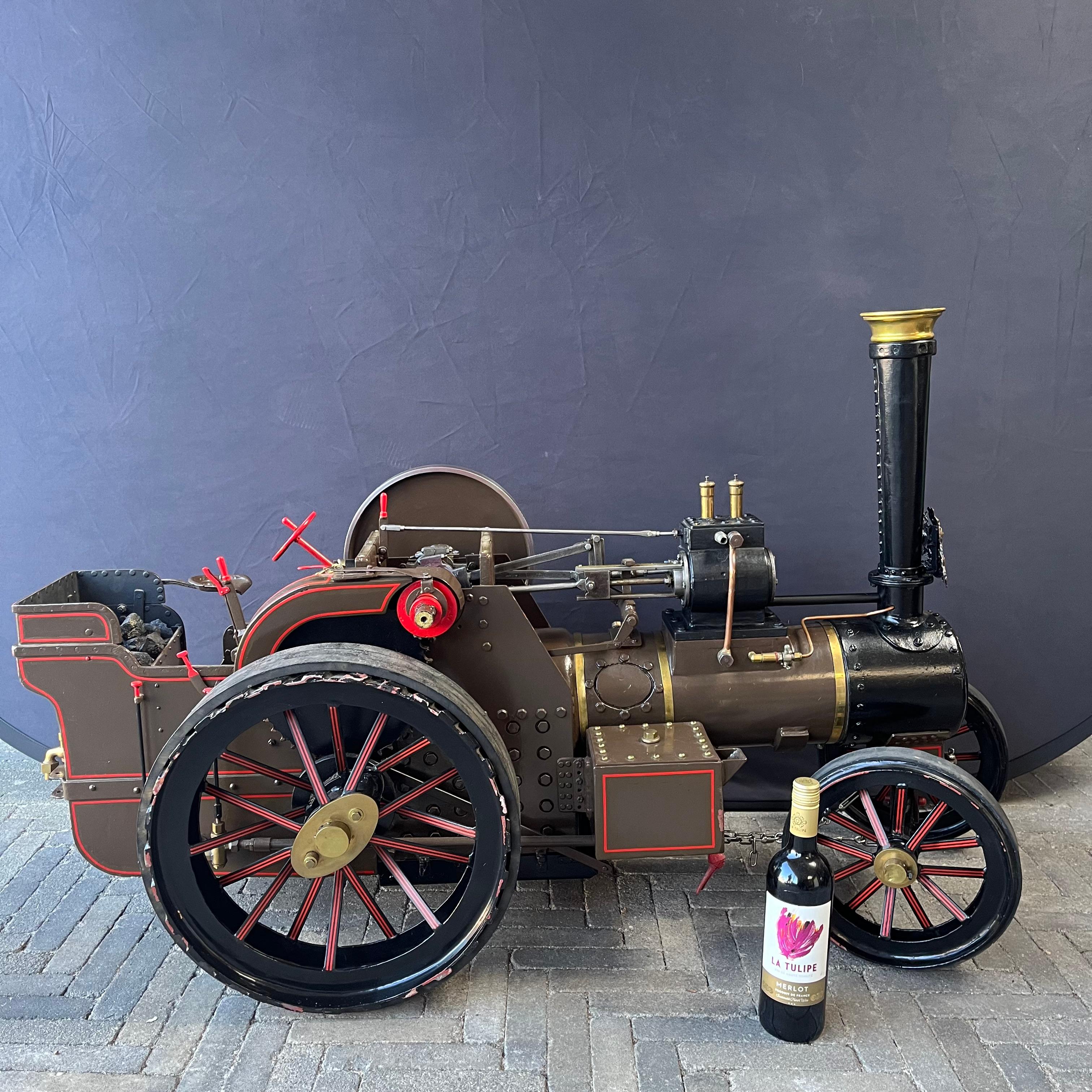 A large live steam 2” scale model traction engine steam tractor in brown livery and brass coat of arms.
The tractor exudes real craftsmanship and is very well made down to the smallest details. 
The 2
