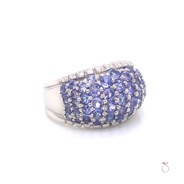 This magnificent natural Tanzanite dome ring in Platrinum is a real beauty. Featuring 49 round brilliant bluish purple Tanzanites totaling approximately 2.00 carats. The Tanzanites are Pave' set in a dome with a scalloped boarder. This gorgeous ring