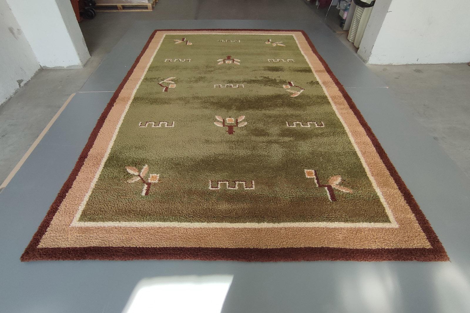 Beautiful sol moss green rug, made of Hand Spun Baby Lambs Wool, in warm shades of green and beige, hand-knotted, stylized floral décor, large size 200x310cm (6.56' x 10.17').
In excellent condition, and professionally washed, this rug is ready to