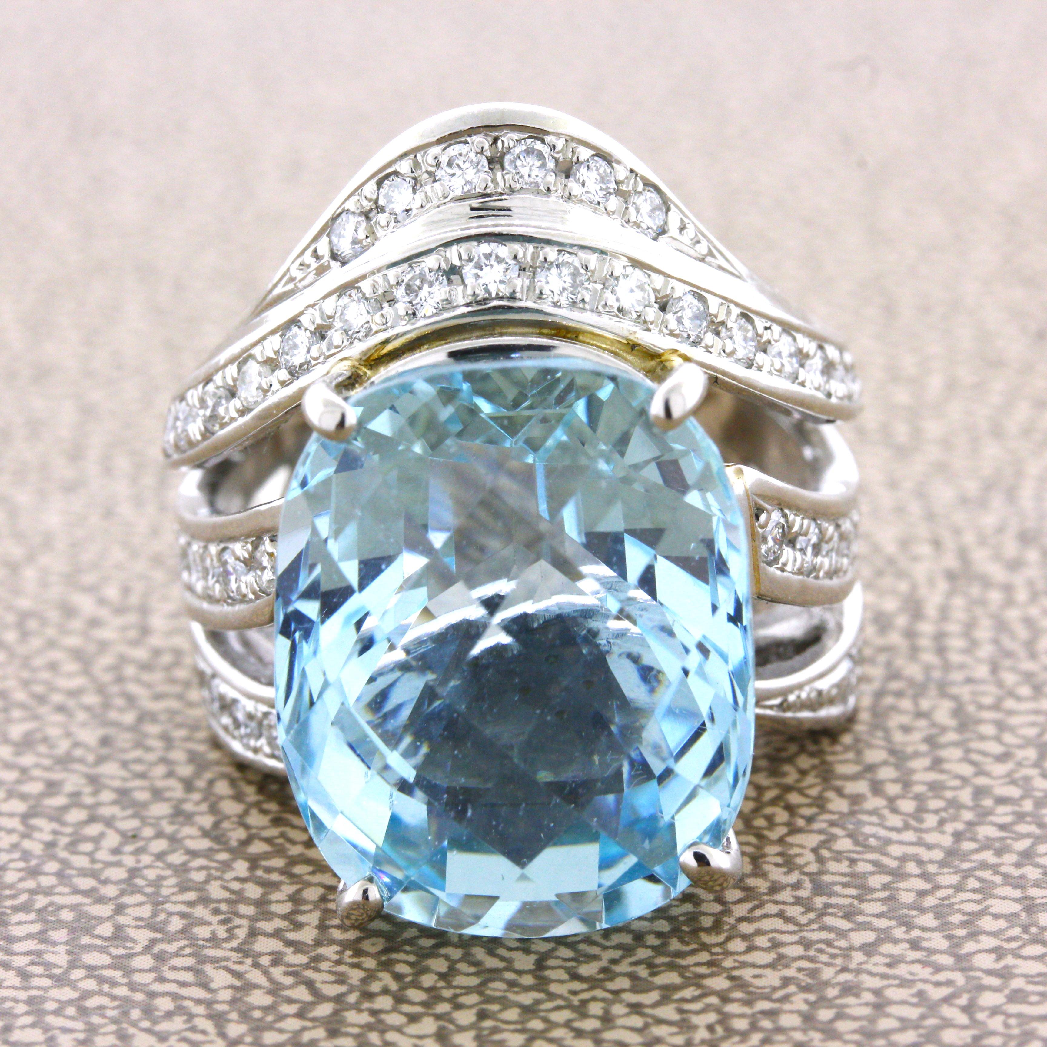 A large and impressive ring featuring a 20.10 carat aquamarine! It has the classic bright sea-blue color that the aquamarine is known for and has a unique rose-cut on its table. It is complemented by 1.00 carat of round brilliant-cut diamonds set in