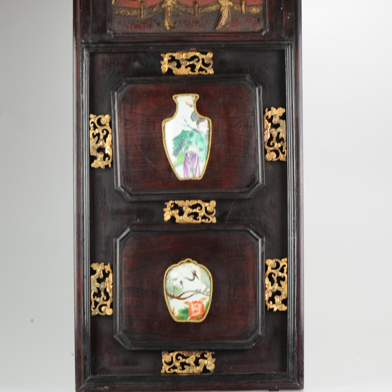 A very nice and unusual example. Large wooden carved frame with 2 porcelain rounded items in it. 1 with a crane and 1 with a woman. The porcelain pieces are round. Made of shards of porcelain broken during the cultural