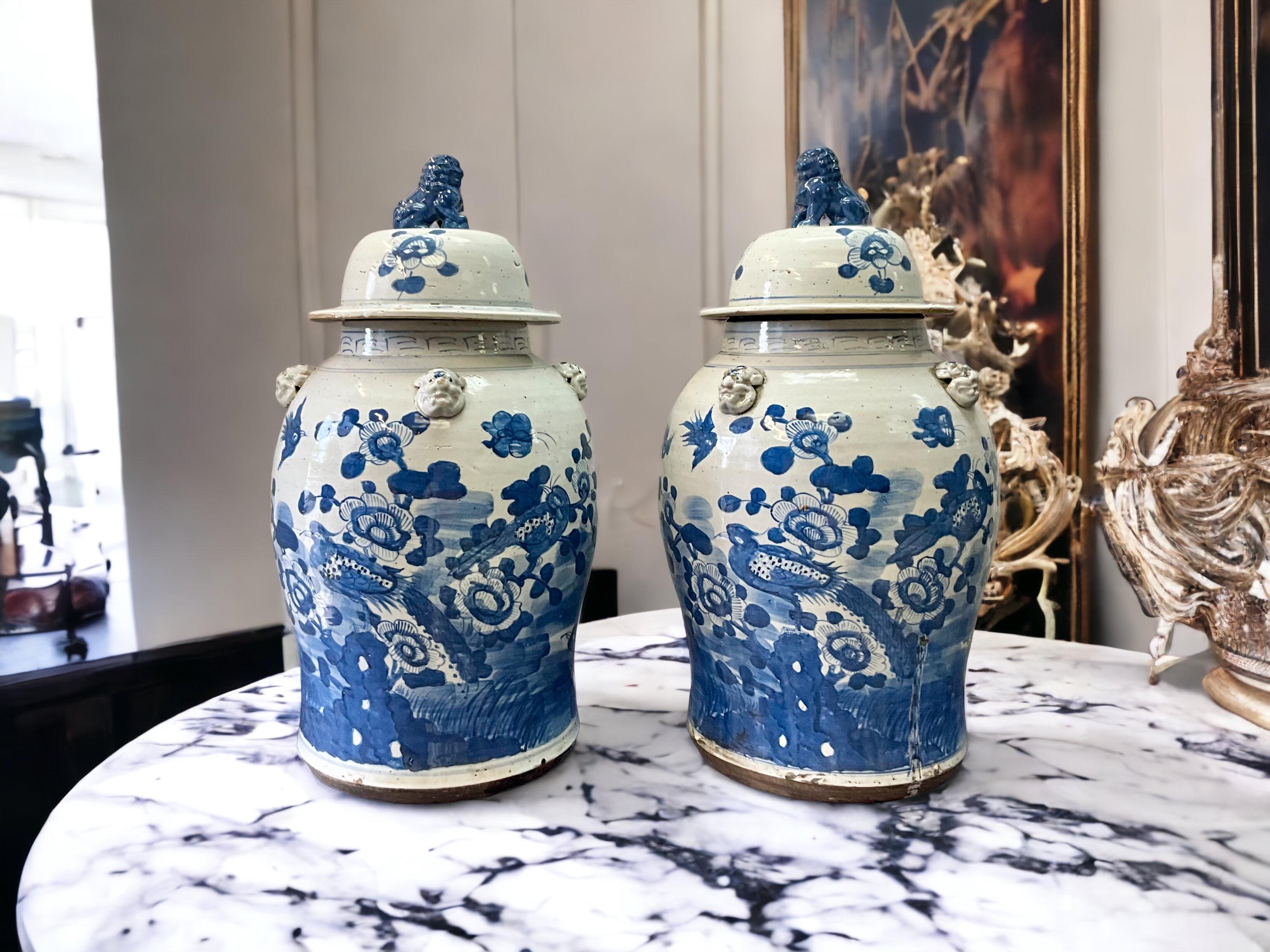 This is a late 20th century Chinese Export style pair of blue and white ginger jars with foo dogs finials and pastoral scenes. They are unmarked and in very good condition. 