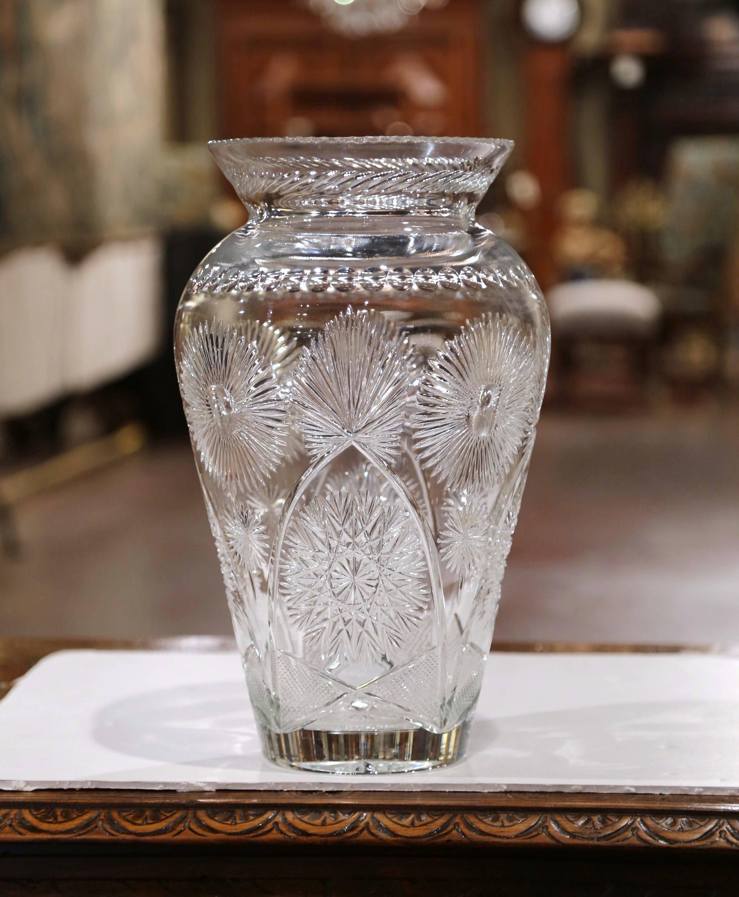 This large elegant vintage cut glass vase was crafted in Europe in the 1980s, it features flower design in high relief. The flower holder is in excellent condition and signed on the front by the artist.
Measures: 16.5