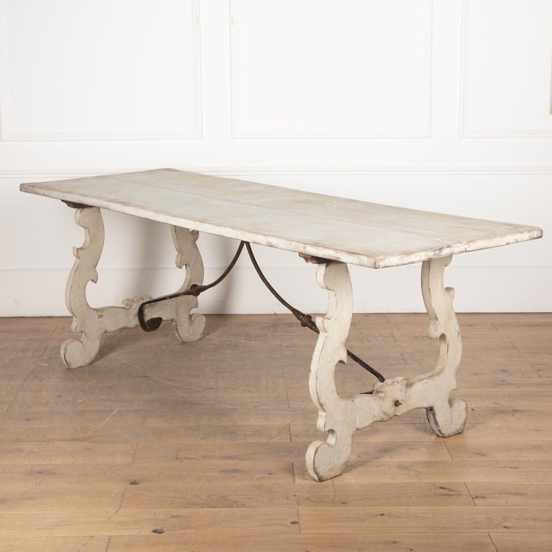 Early 20th century painted dining table with curved legs and wrought iron centre brace.
Circa 1920.