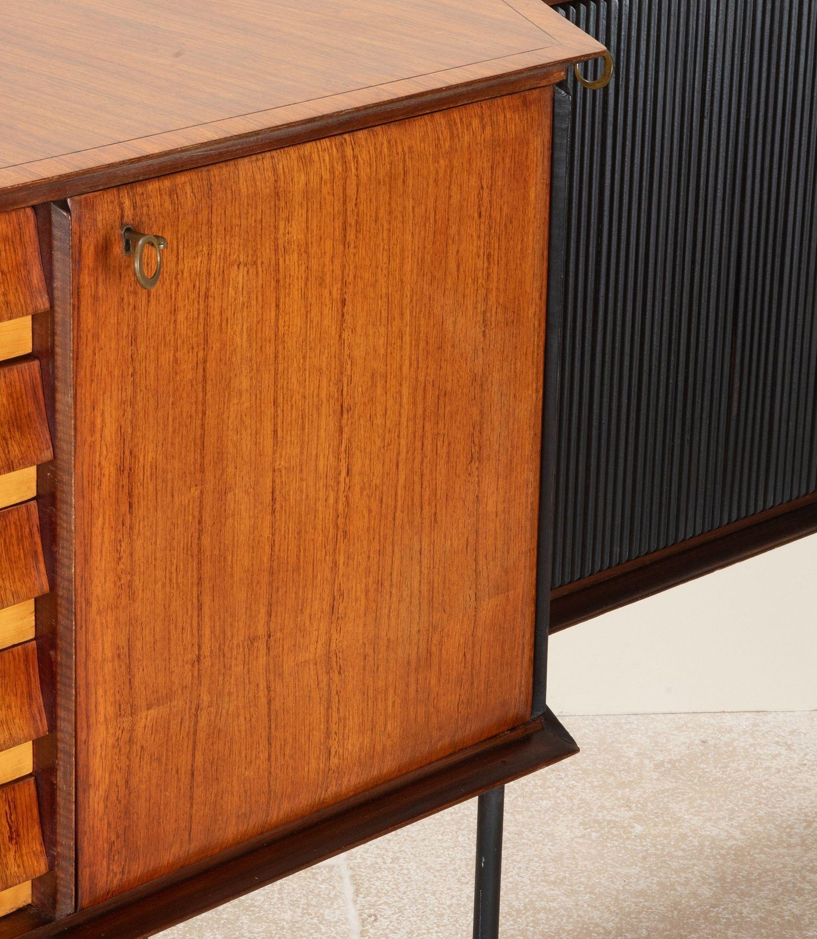 Large and very wide Mid-Century Italian multi section sideboard.
With drawers and cupboard sections flanked by shallow cupboards and ebonised, fluted doors. Legs in lacquered metal with brass feet.
Designed by Vittorio Dassi, Circa 1960.