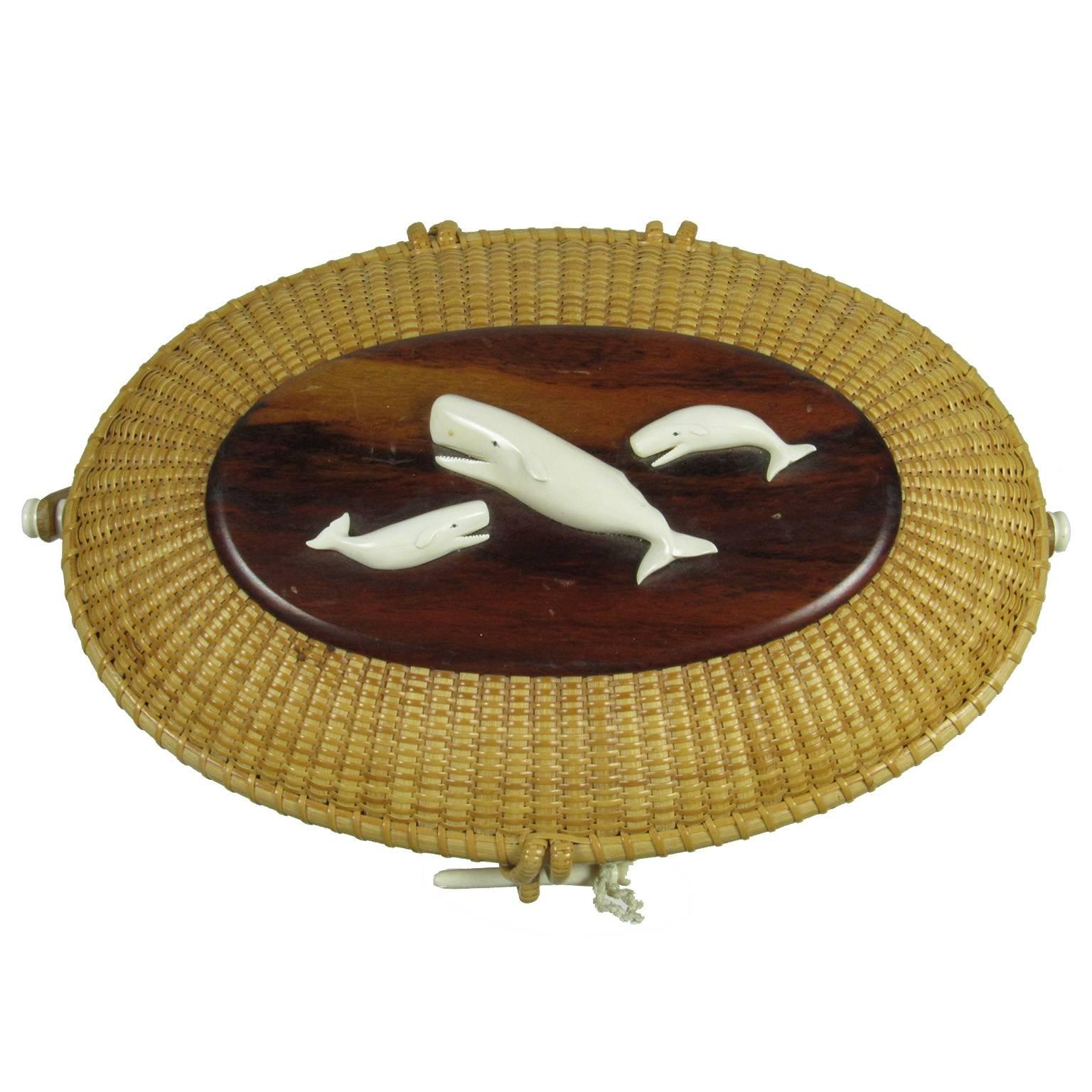 Susan Chase Ottison very large oval swing handled Nantucket basket adorned with a carved bone female whale (cow) and two calves. Signed and dated on bottom 