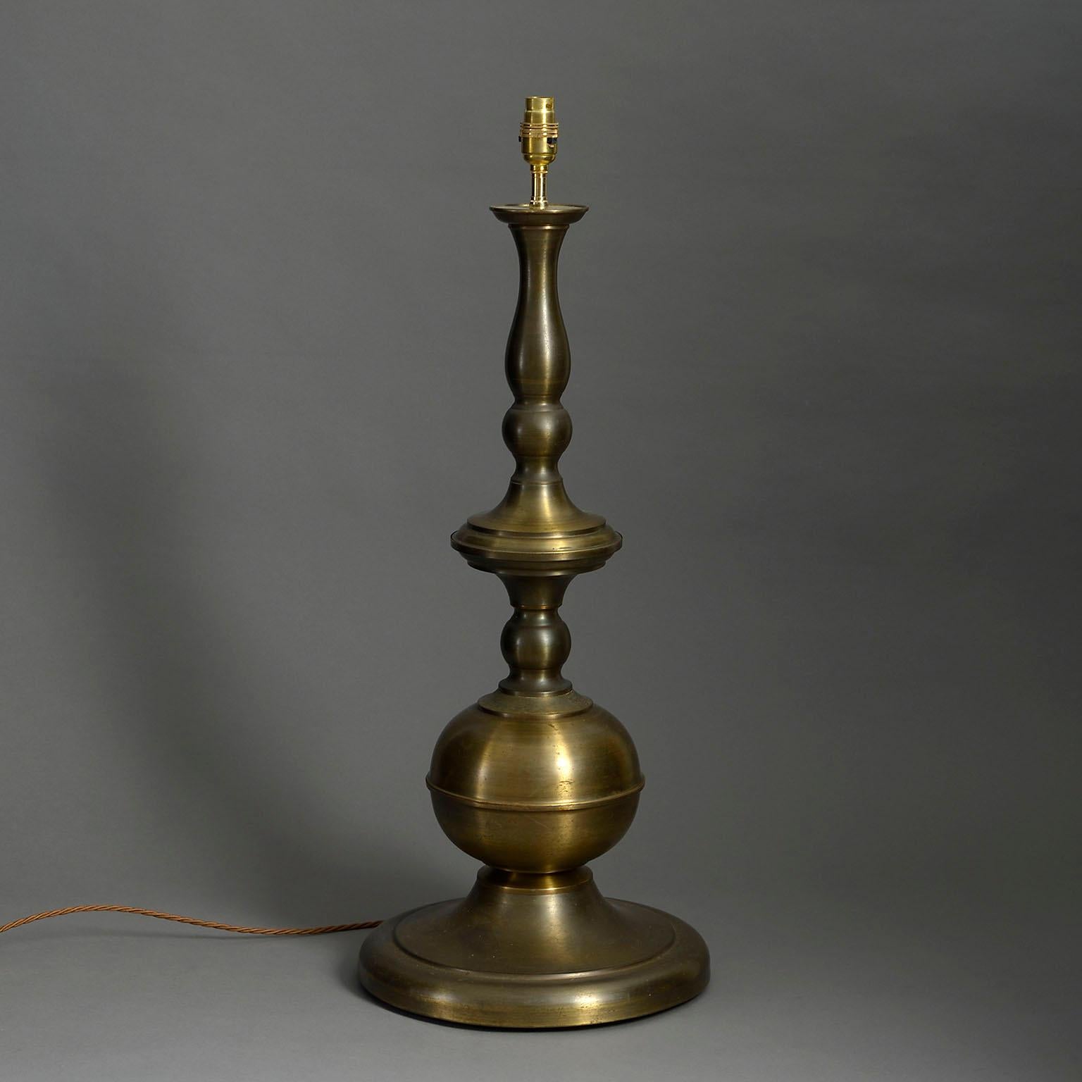 A mid-twenteith century turned brass lamp base of great scale and soft patination.

Dimensions refer to brass base and exclude electrical fittings.

Wired to UK standards. This lamp can be rewired to all international specifications inclusive of