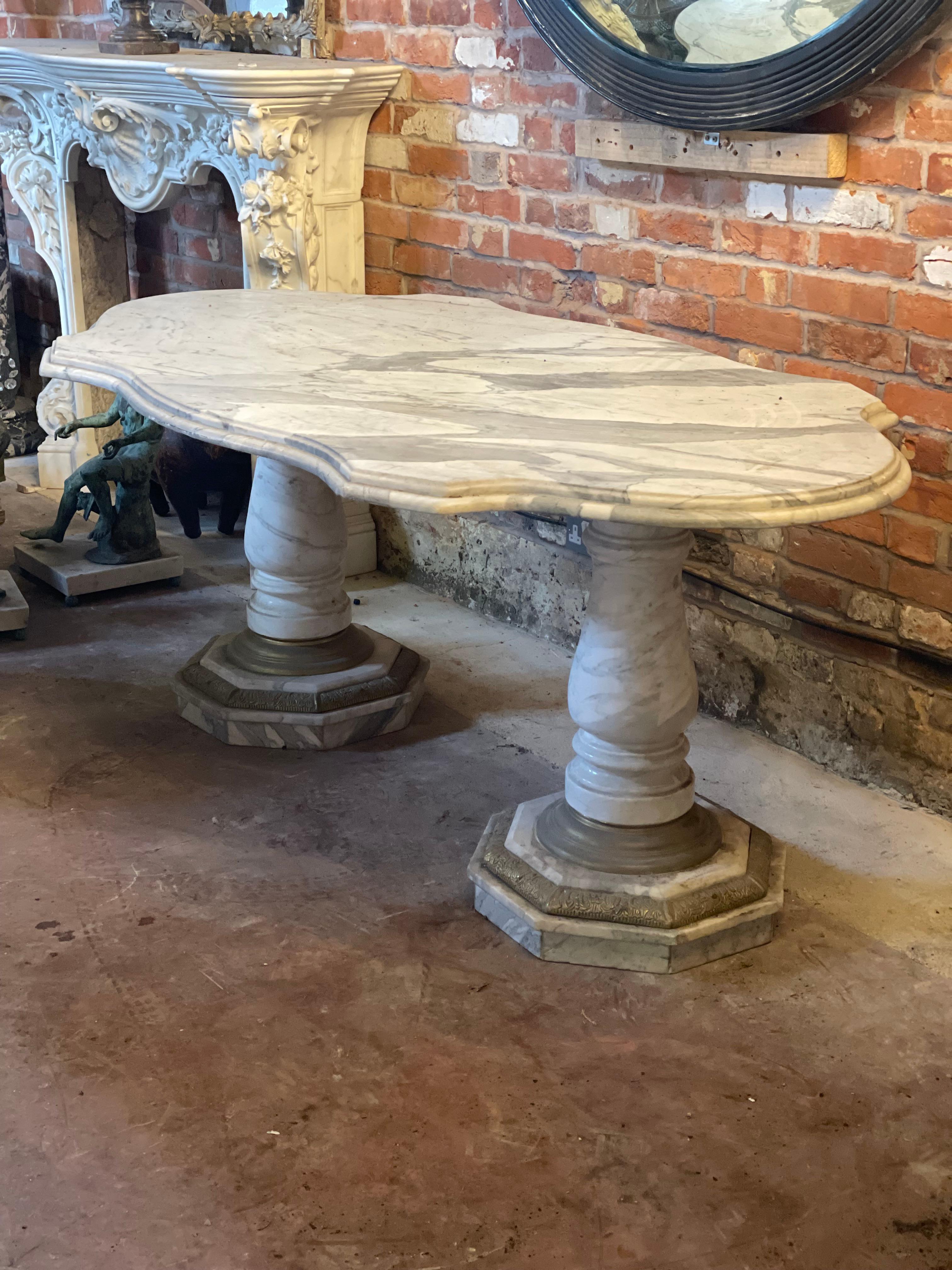 Large 20th century twin pedestal Carrara marble center table. Pedestals with decorative brass banding to the base.
   