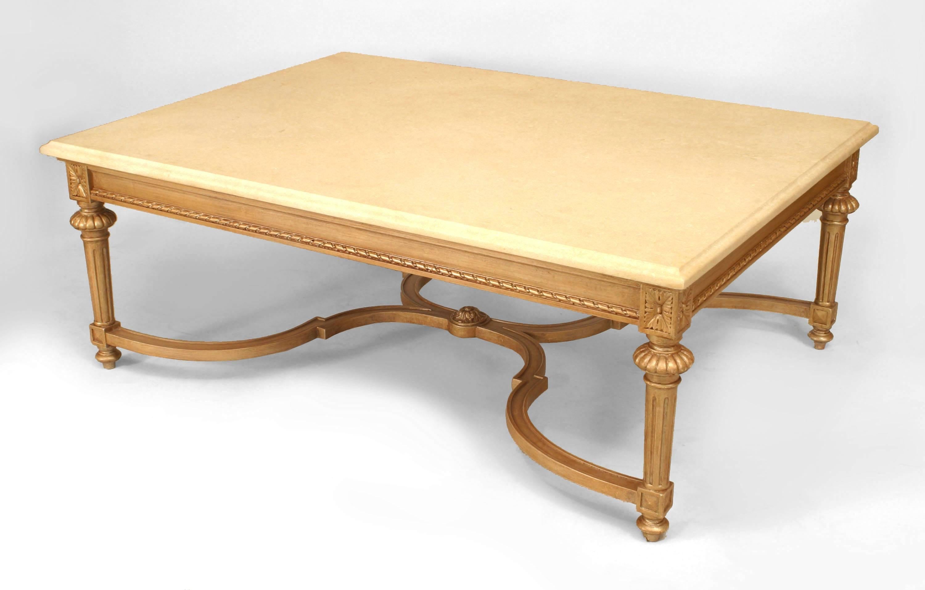 20th century French Louis XVI style large gilt rectangular coffee table with a shaped stretcher and beige marble top.