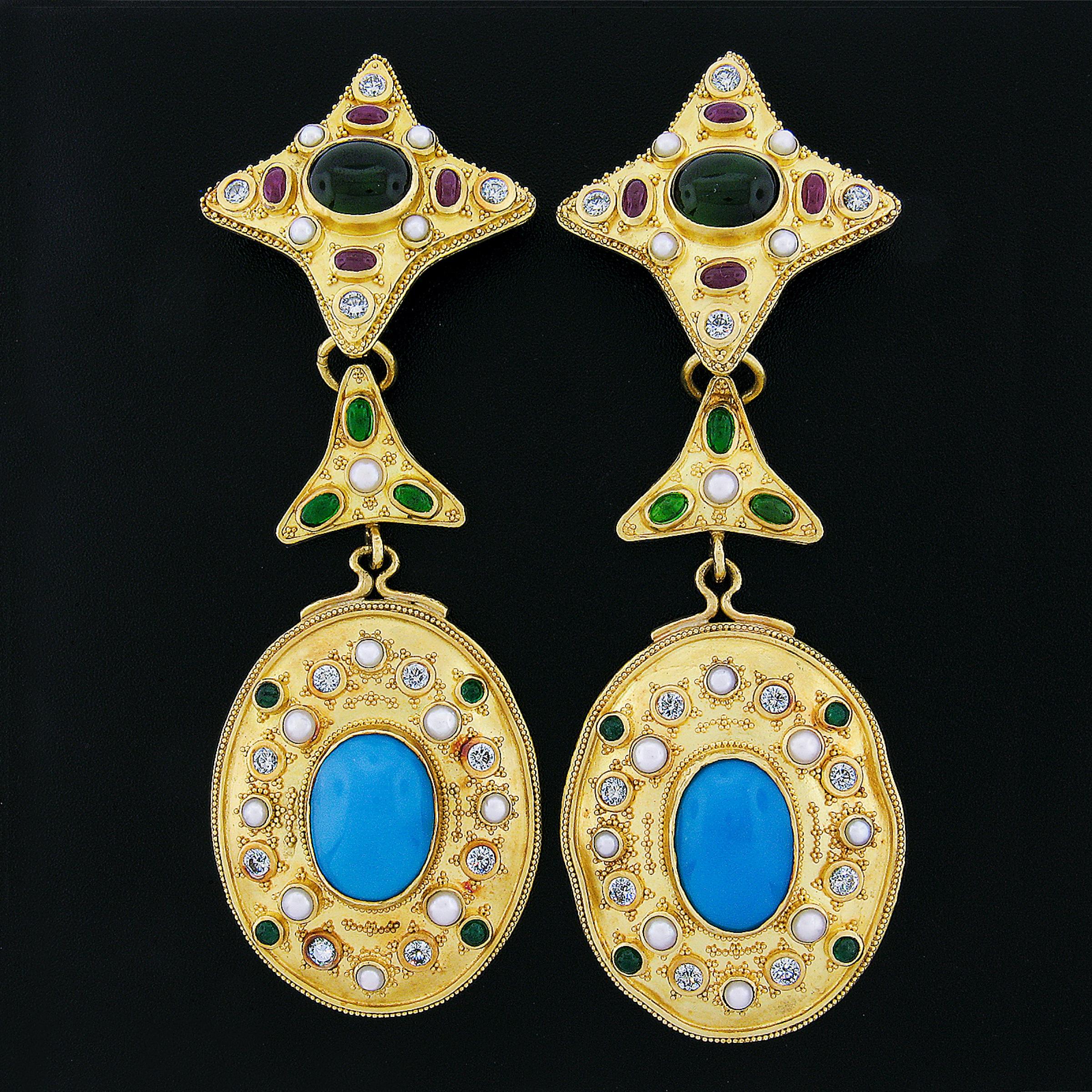 These magnificent and substantial pair of earrings are crafted in solid 22k yellow gold and feature a large and long design hand set with fine quality diamonds, tourmalines, rubies, turquoise and cultured pearls. The earrings are also encrusted with