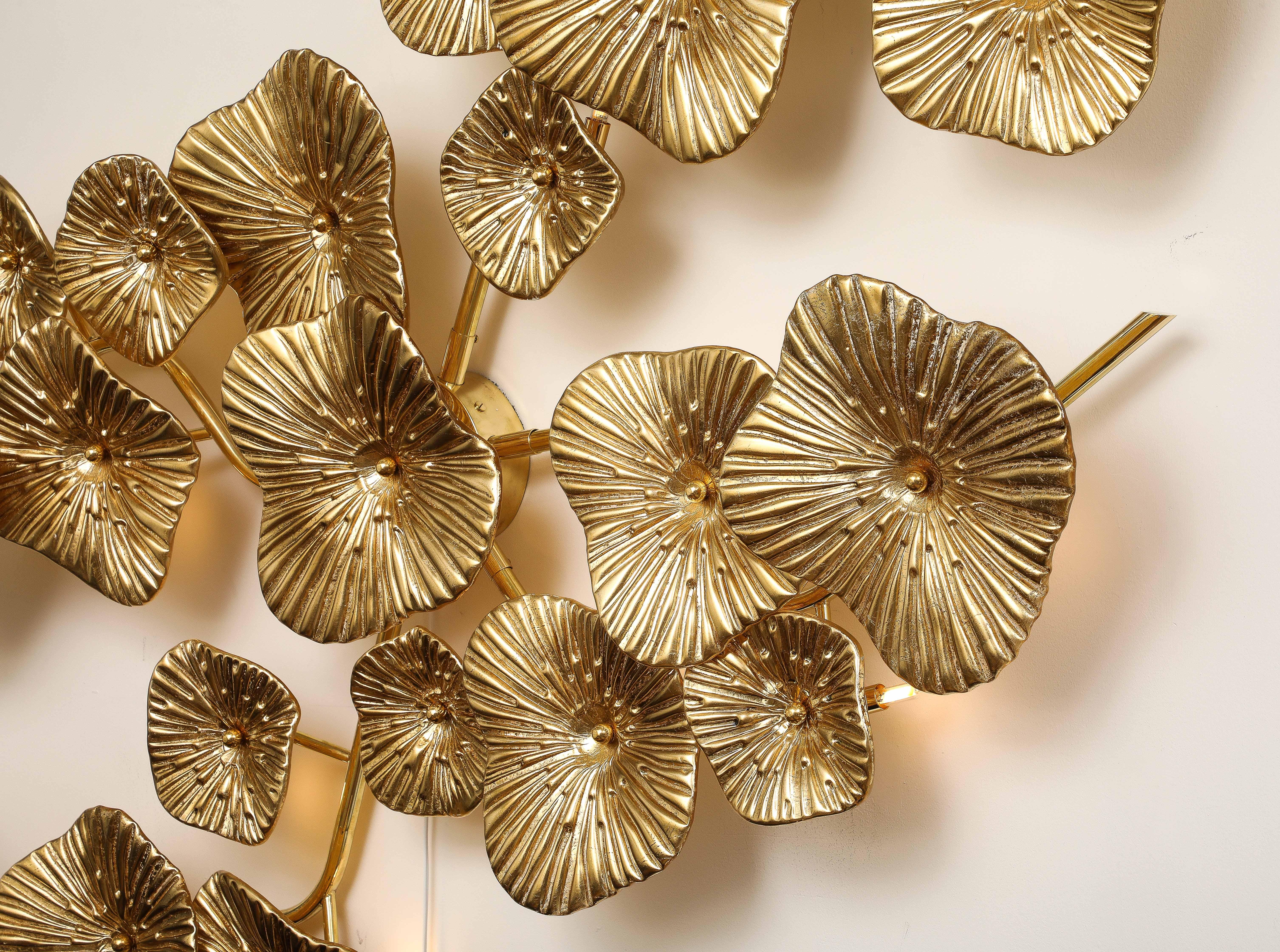 Very Large and unique Gold Leaf Murano glass flowers sconce or wall art with brass frame. Hand-casted and formed Murano glass flowers with hand-applied, 24k gold leaf on reverse of glass are attached with a brass caps to brass stems. The Murano