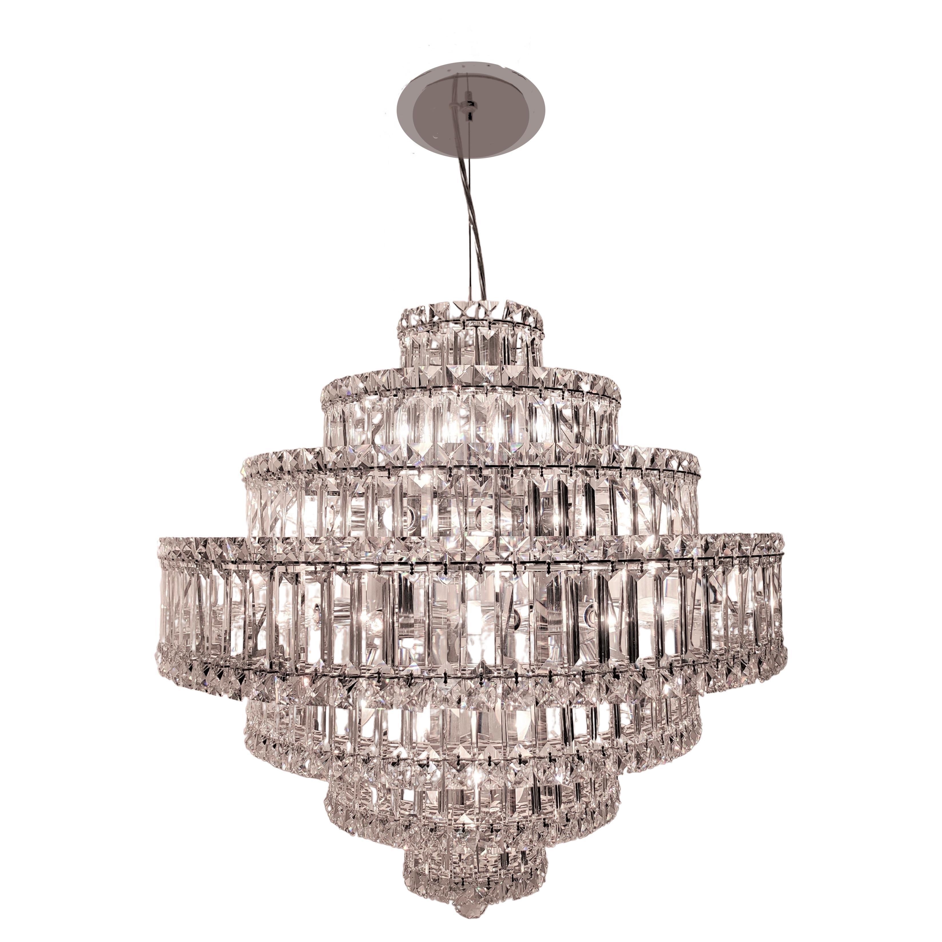 The dazzling Plaza pendant crystal chandelier designed by Schonbek
exudes elegance as it is adorned with highly shimmering square and rectangular Swarovski crystal gems. Its sleek geometric construction and stepped multi -tiered waterfall design
