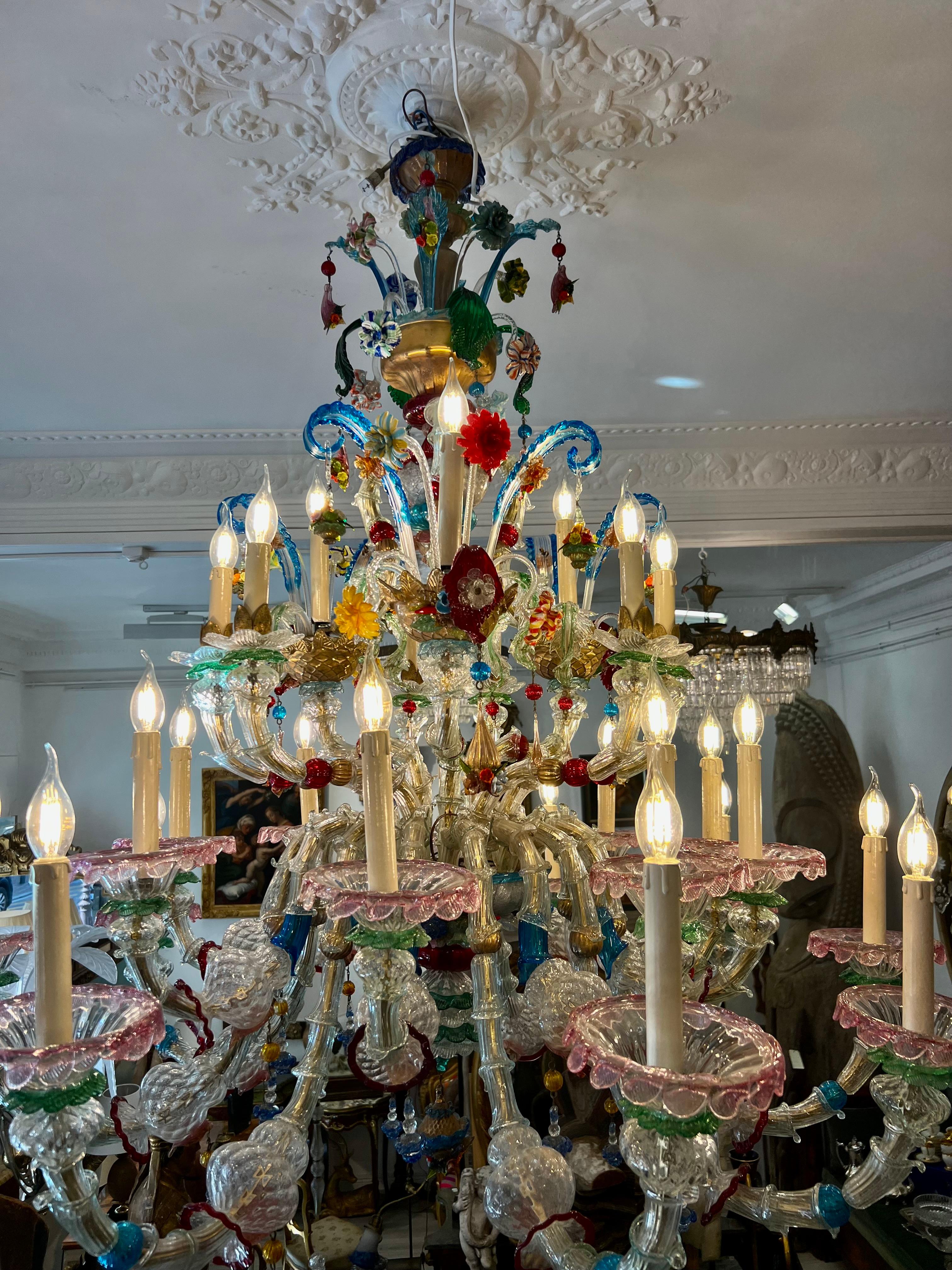Murano glass rezzonico chandelier multicoloured flowers 27 lights early 20th Italy This chandelier stands out for its vivid multitude of colours, which make it an outstanding example of the best Murano glass art. 27 Arms spread out from the central