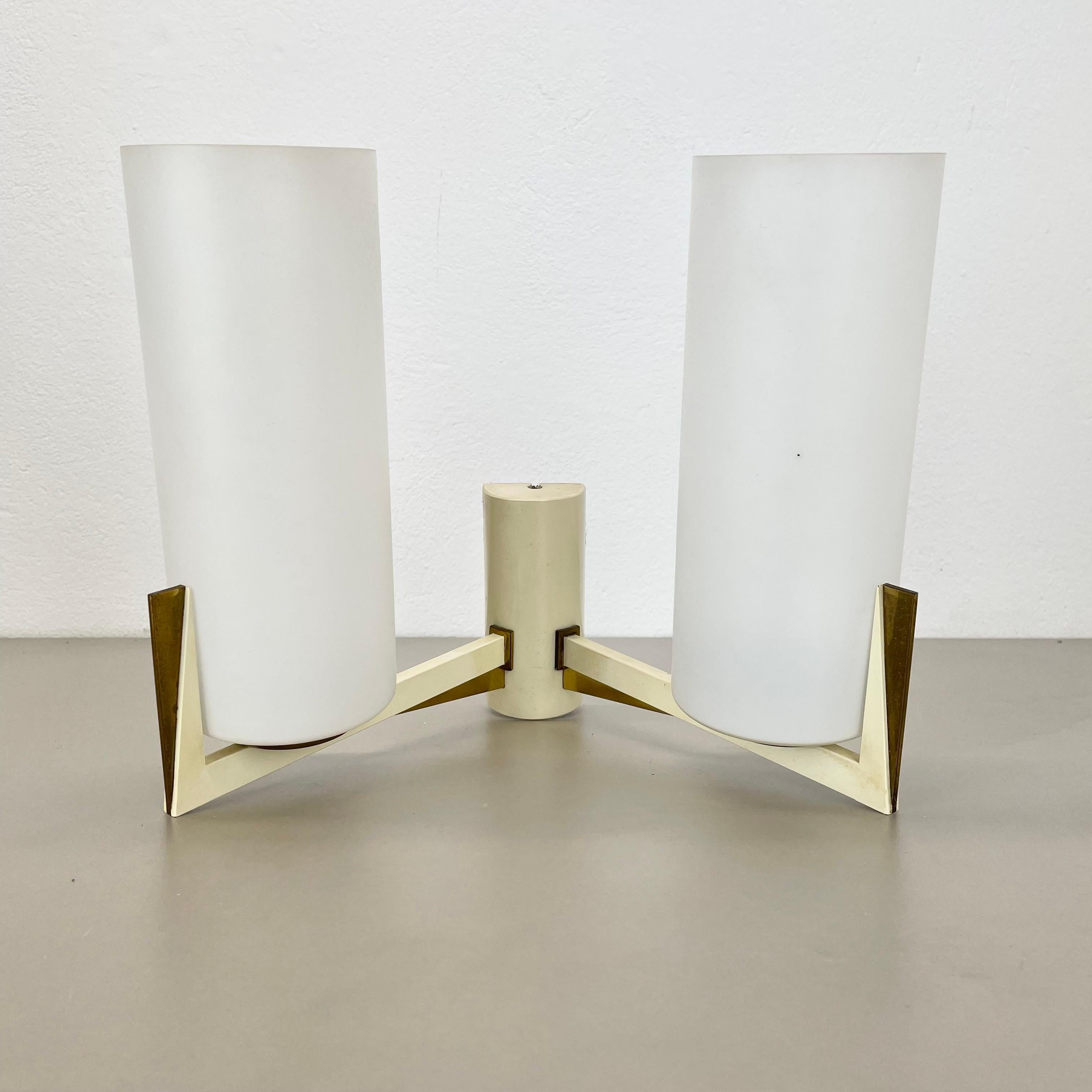 Article:

Brass wall light


Producer:

Origin France


Age:

1950s



This modernist wall light was produced in France in the 1950s. It is made from solid brass with a large tube satin white glass shade element at the front. Super rare theatre wall