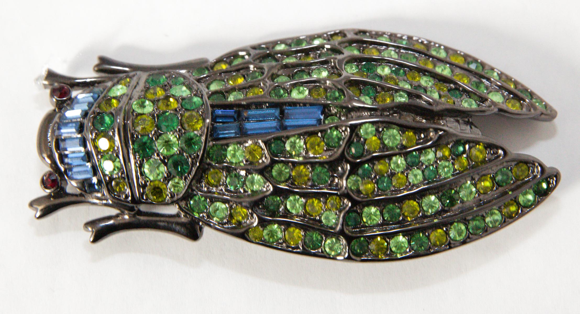 If you lived in Paris, you know they love Cicada jewelry and the woman collect as many as they can find.   You’ll love this Cicada brooch.  It has different hues of green crystals throughout its wings.  The head has blue crystals and red eyes in a