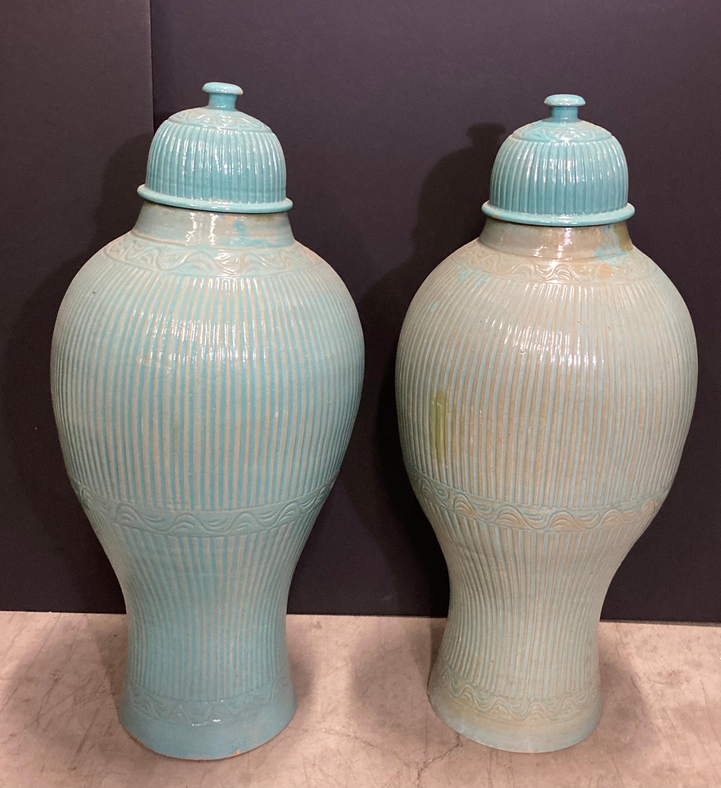 Aqua blue hand-crafted pair of large Moroccan ceramic urns with lid. Measures: large 3'.
Hand-made Moroccan Moorish style turquoise ceramic jars or large vases.

