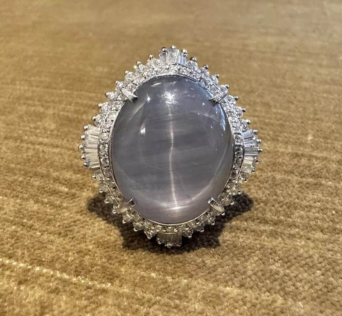 Large 30 carat Natural Star Sapphire & Diamond Ballerina Ring in Platinum 

Star Sapphire and Diamond Ring features one Natural Oval Cabochon Star Sapphire with grayish blue color and weighing 30.10 carats surrounded by two rows of Natural Round and