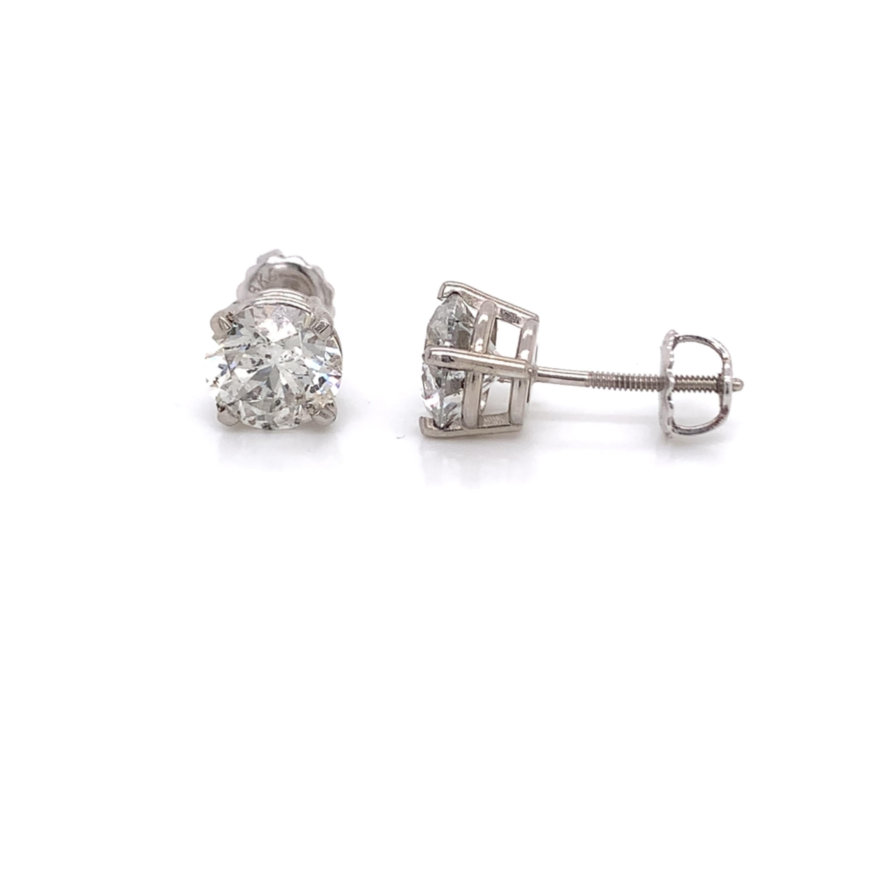 Diamond stud earrings made with real/natural brilliant cut diamonds. Total Diamond Weight: 3.02 carats. Diamond Quantity: 2 round diamonds. Color: F-G.  Clarity: I1. Mounted on 18kt white gold screw-back setting.