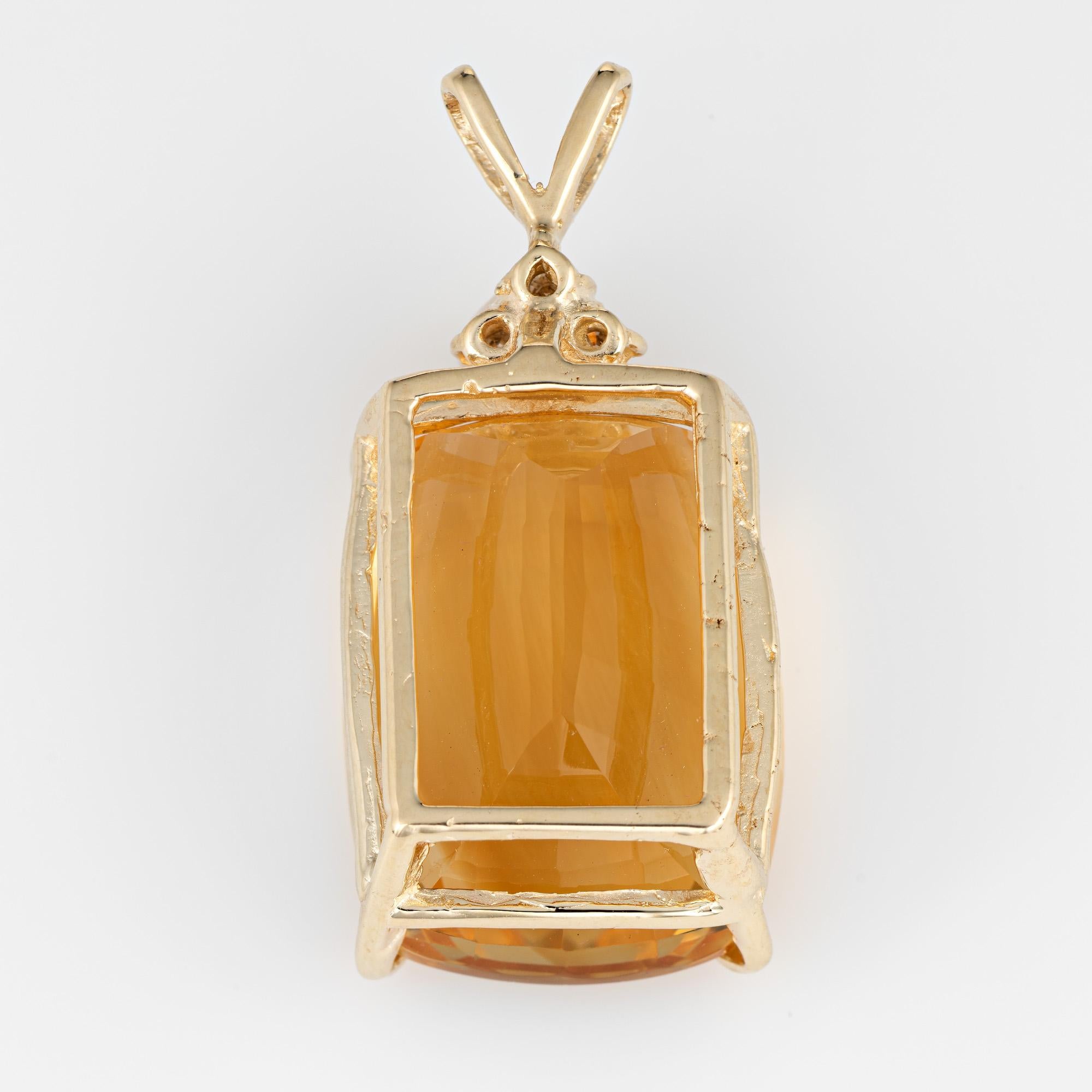 Finely detailed large vintage citrine & diamond pendant (circa 1960s to 1970s) crafted in 14k yellow gold.   

The citrine measures 22.5mm x 16.5mm (estimated at 31 carats). The citrine is in excellent condition and free of cracks or chips. The