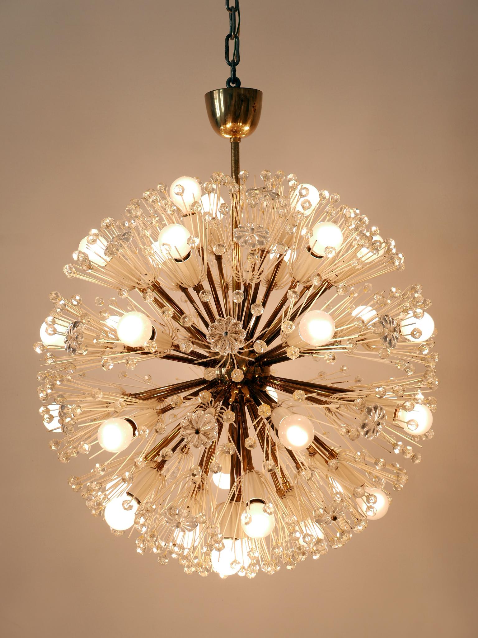 A breath taking light object. Rare, lovely and highly decorative Mid-Century Modern 33-flamed sputnik chandelier 'dandelion'. Designed by Emil Stejnar for Rupert Nikoll, Austria, 1950s.

Executed in brass, glass pearls and flowers, the chandelier