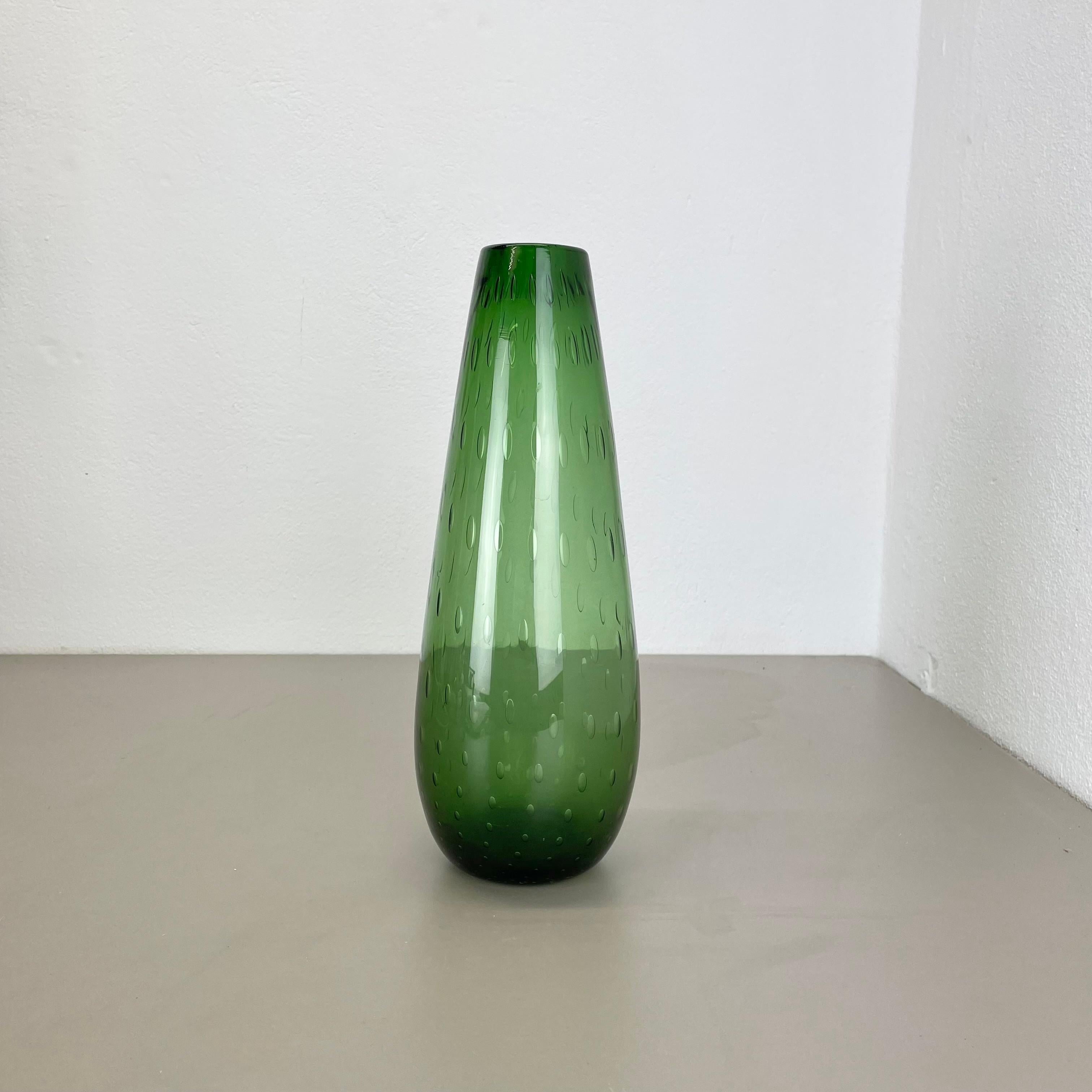 Article:

Murano glass vase element


Origin:

Murano, Italy


Decade:

1970s


This original glass vase element was produced in the 1970s in Murano, Italy. An elegant green Murano glass element utilizing the bullicante technique of controlled
