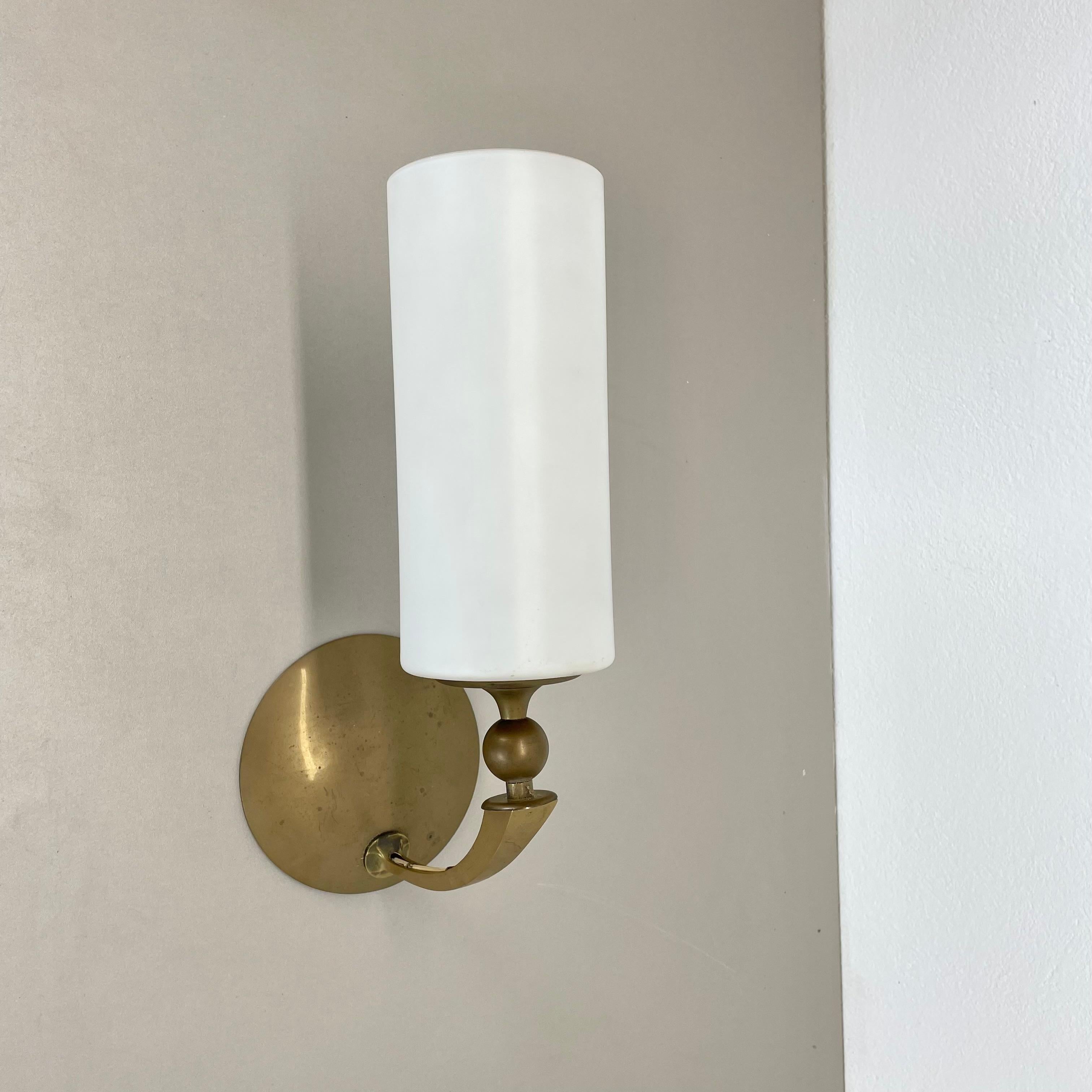 Article:

Brass wall light


Producer:

Origin France


Age:

1950s



This modernist wall light was produced in France in the 1950s. It is made from solid brass with a large tube satin white glass shade element at the front. Super rare theatre wall