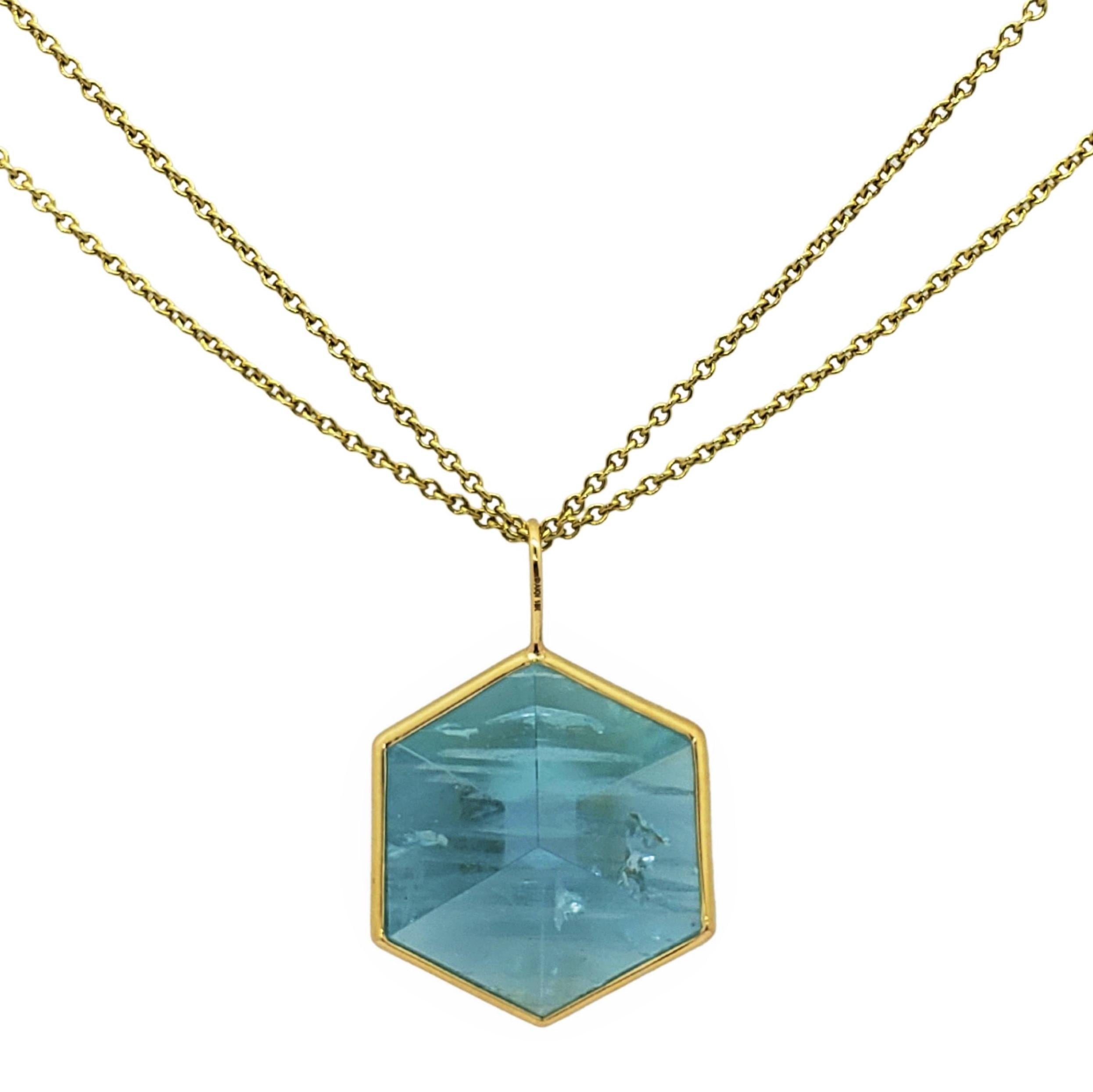 Non-gender Unique Natural Brazilian Aquamarine in 3D cut wrapped in a handmade 18K yellow gold bezel statement necklace. The new 3D cut is an optical illusion if viewed from different angles. In one position, it appears to be a cube, but then it