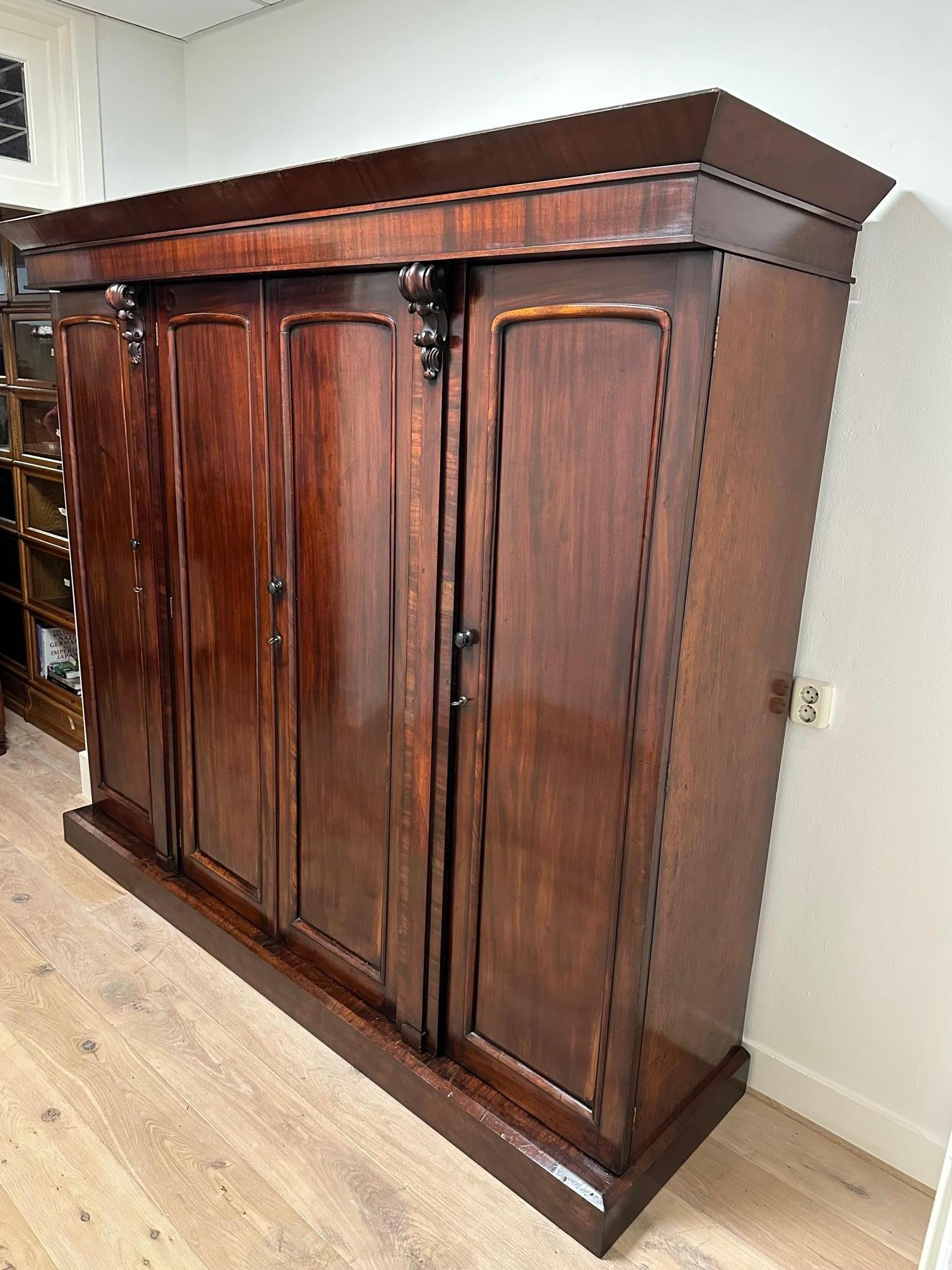 Beautiful sleek antique wardrobe from the Victorian era. The cabinet is in good and original condition. Beautiful weathered patina.
What makes the cabinet beautiful is that it is a 4-door version without mirrors in the doors.