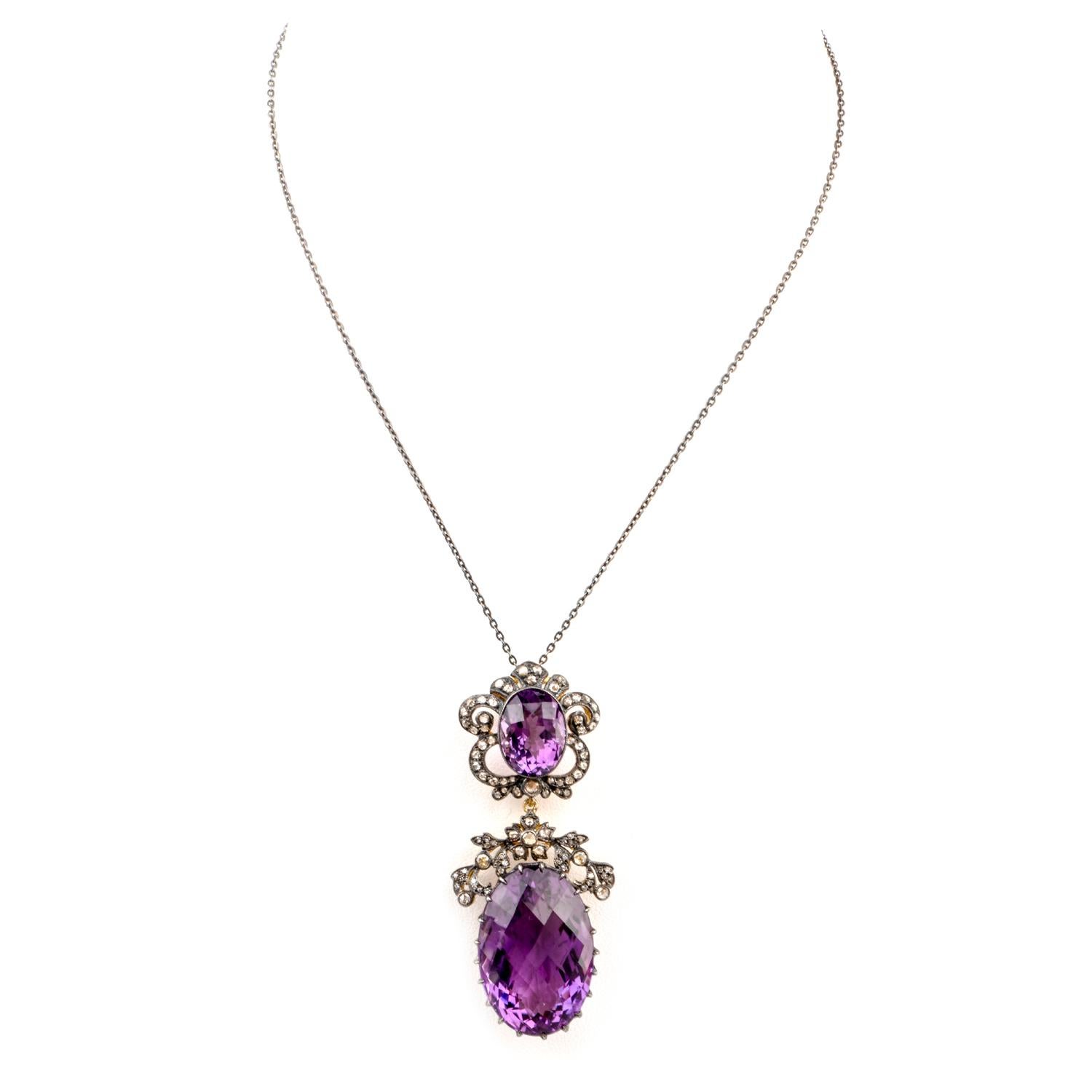 This estate pendant suggests nobility with a sensual lacing pattern

around the Amethysts and crafted in silver.  Featuring a large oval shaped Amethyst at the 

bottom, this stone measures appx. 27 x 17.18 x 13.15mm and weighs appx. 33.50