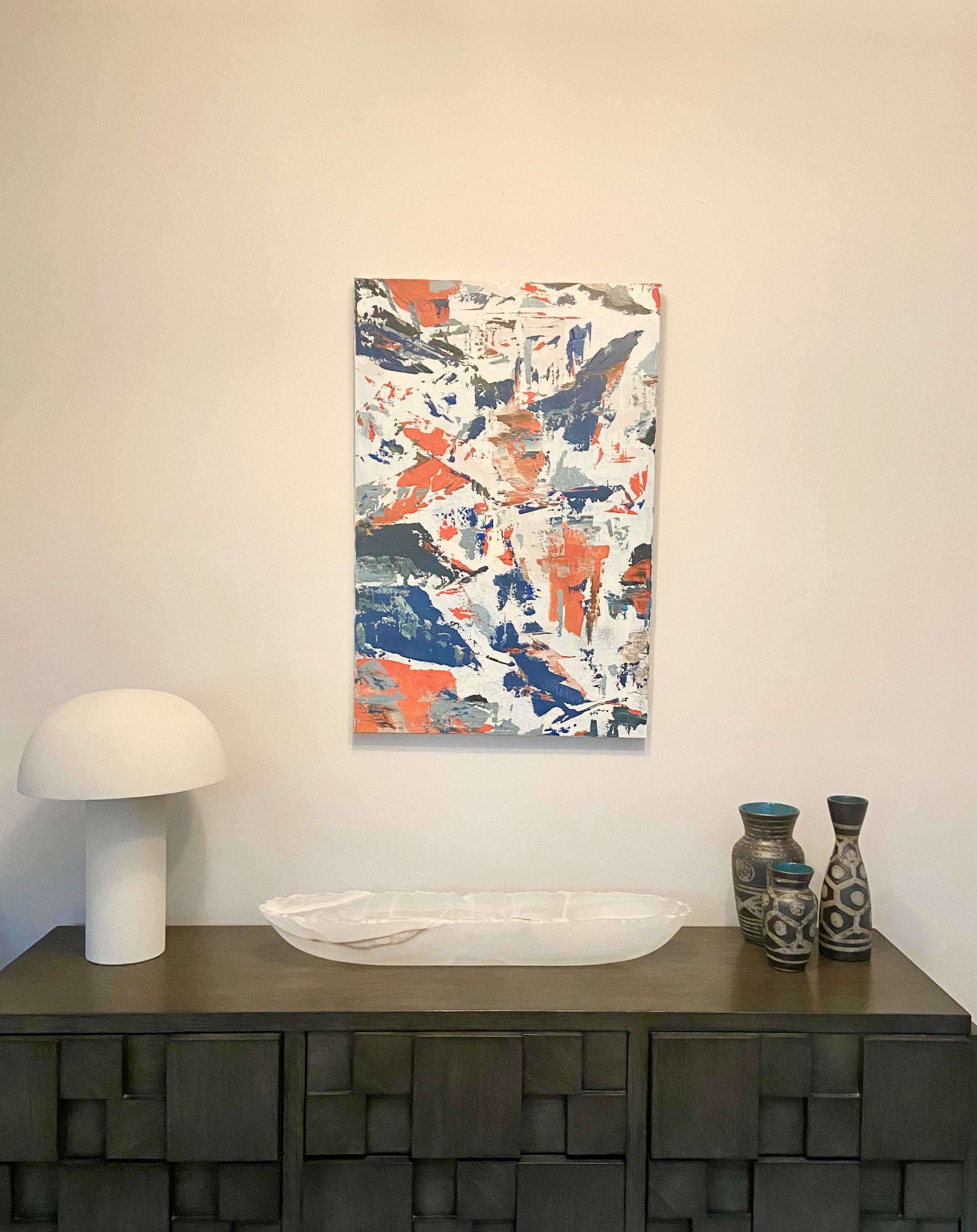 The blue depth of the sky and the bright orange of the earth blend together in an abstract, dense composition by artist Lana Sexton. Inspired by the desert landscape, this painting seeks to capture the essence and energy of nature. The intricate and
