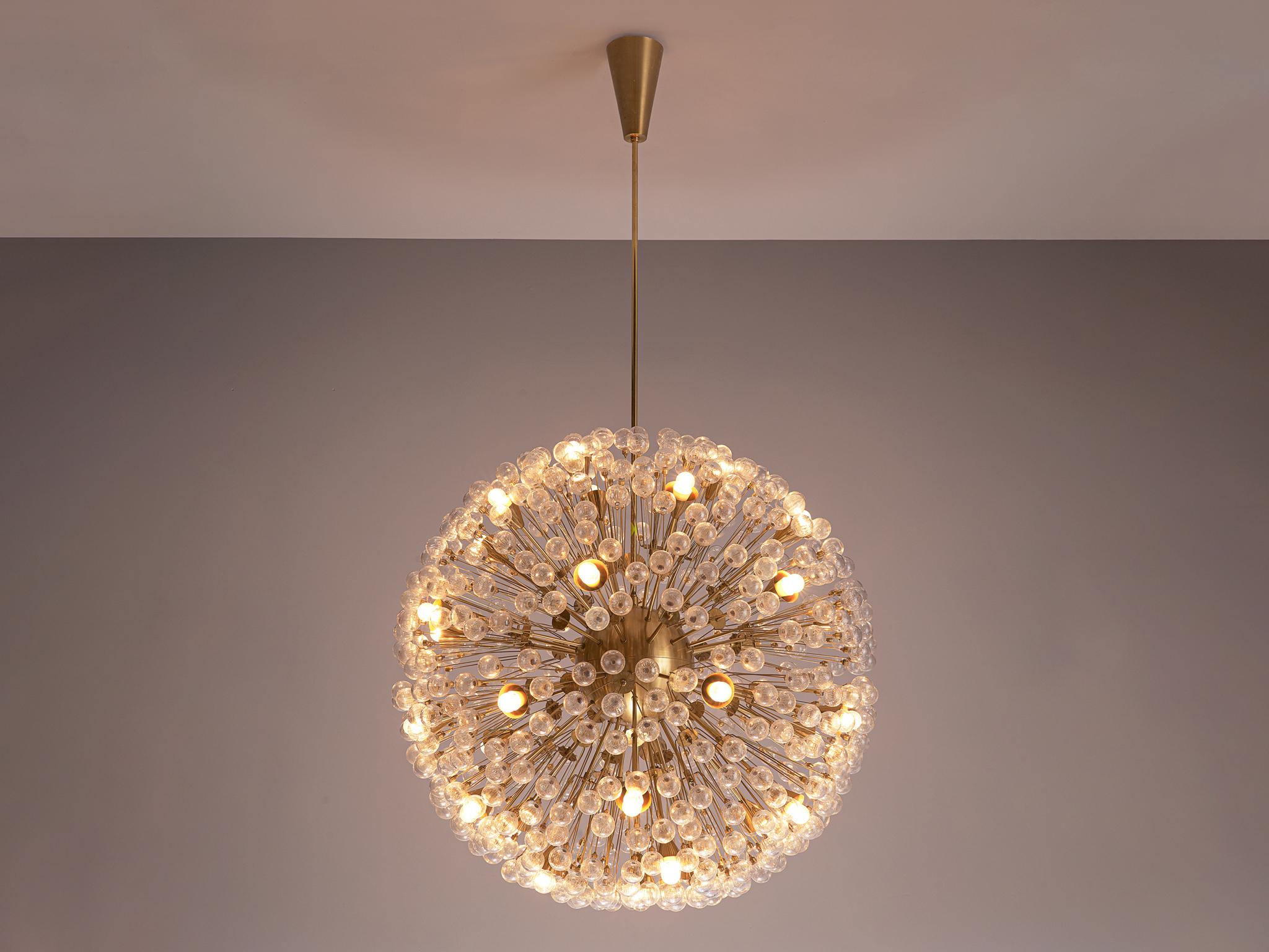 'Sputnik' chandeliers, brass, glass, Austria, 1960s

Round like a ball this 'Sputnik' chandelier consists out of a center sphere from which many rods with glass spheres at their ends are held. The small spheres are made out of structured glass and