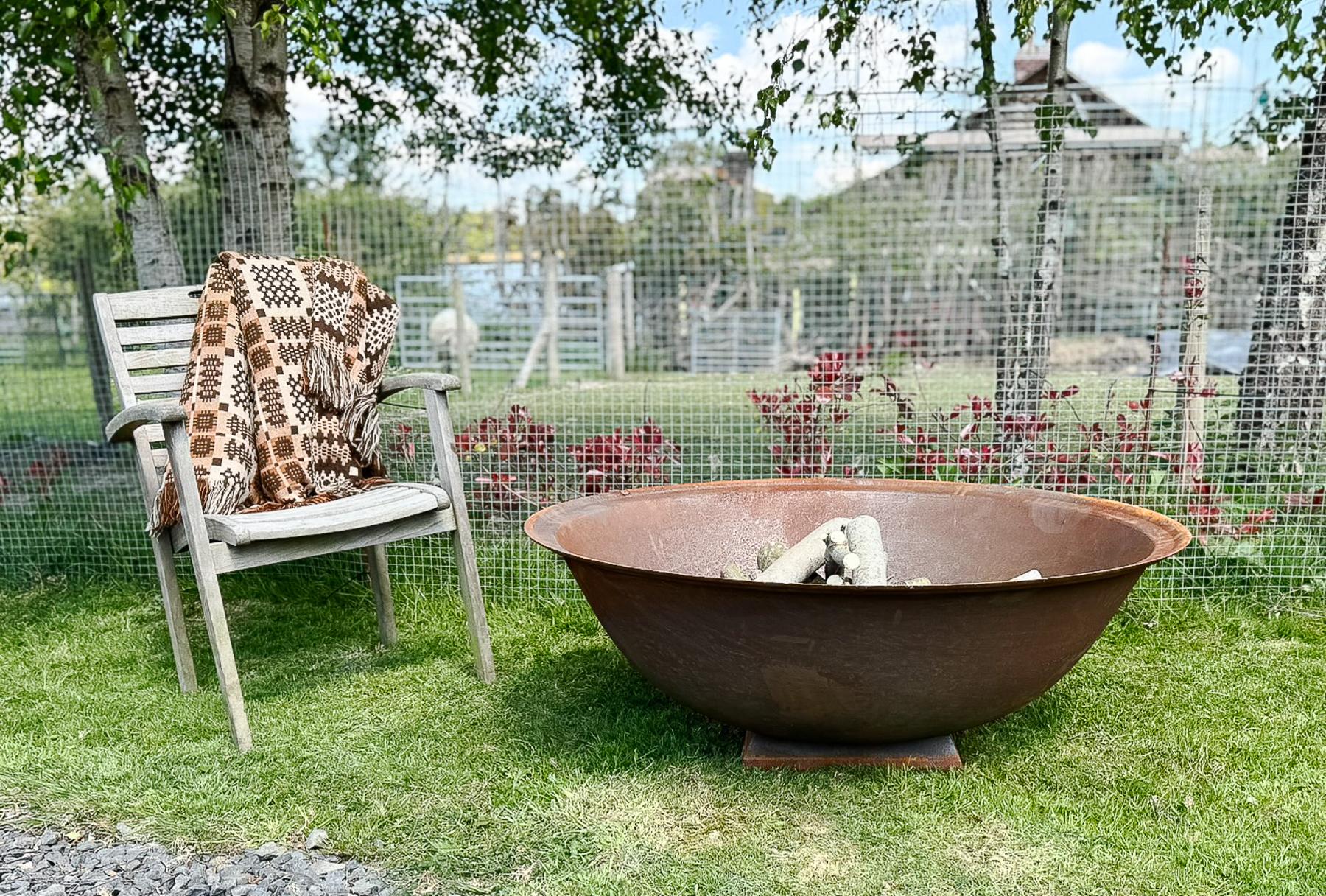 Enhance your outdoor experience with our stunning 4ft cast iron fire pit, featuring a natural rust patina that adds rustic charm. This beautifully crafted deep dish fire pit provides ample space for larger logs, making it a perfect centrepiece for
