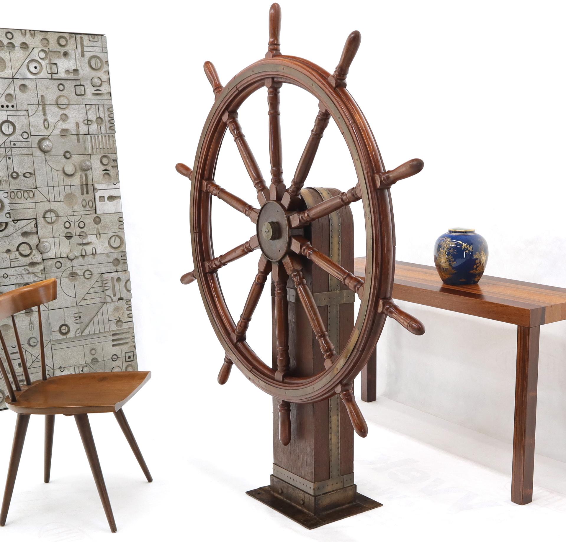 Large decorative display 5 feet in diameter ships wheel Kinetic sculpture. Nicely weathered wood post.