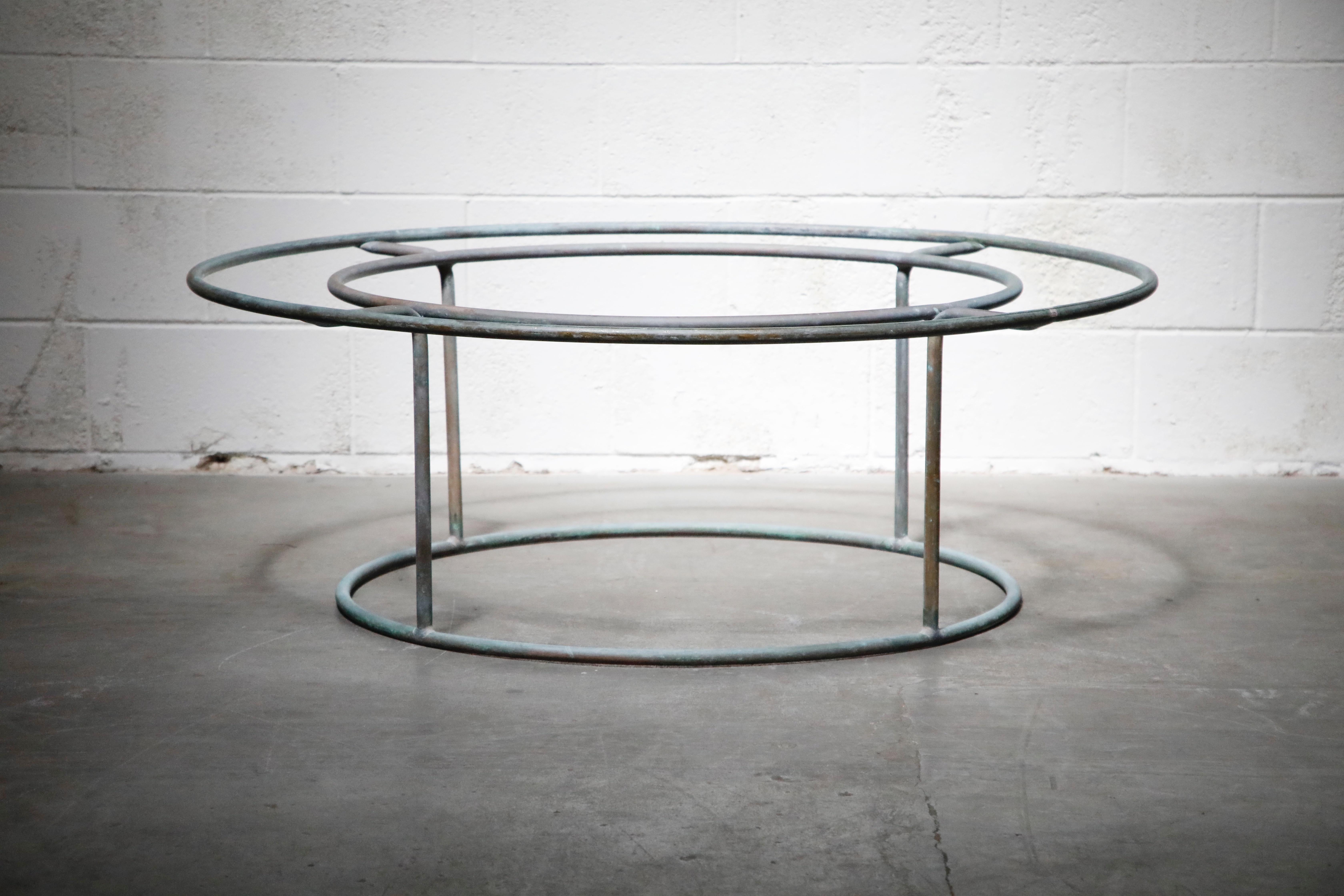 This highly-sought-after and collectible patinated copper patio coffee table was designed by Walter Lamb and produced by Brown Jordan. This rare original production example is from the earlier years of Lamb's work with Brown Jordan, dating to the