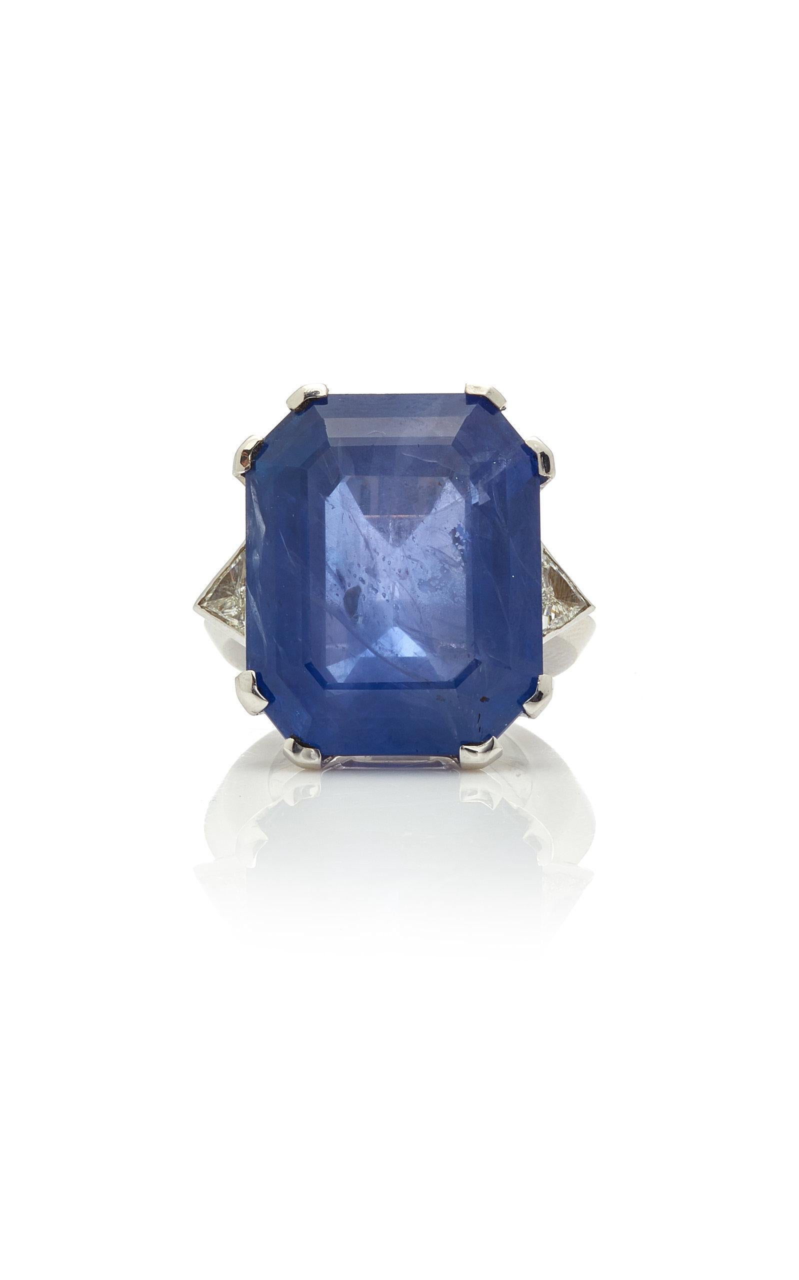 A showy ring mounted on 18kt white gold, highlighted with triangular cut diamonds, showcasing a large rectangular cut sapphire (ceylon origin, 50 cts). Made in Italy, circa 1960s.