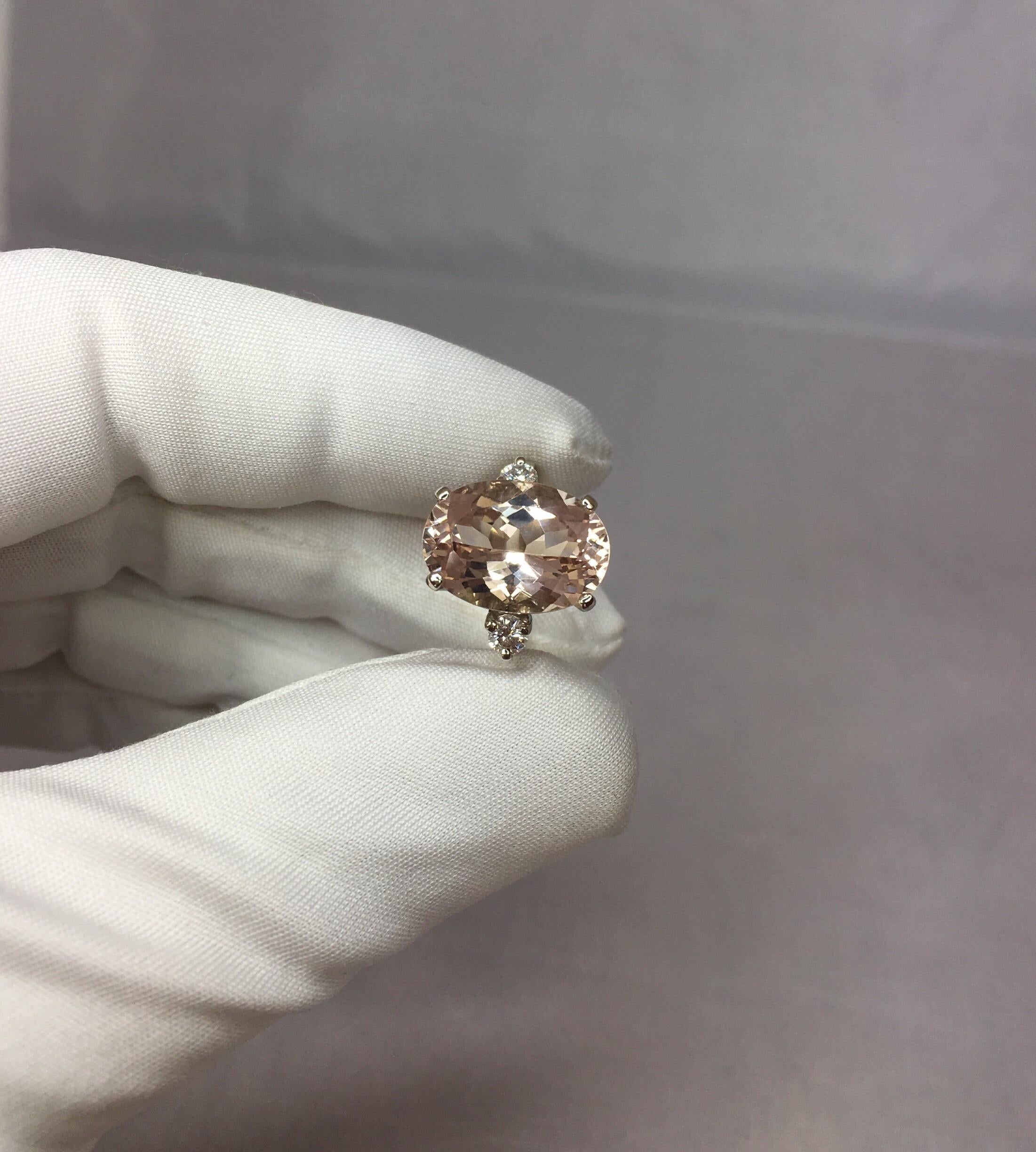 Fine natural morganite and diamond white gold three stone ring.

Large 5.87 carat morganite with a stunning vivid peach pink colour and excellent clarity. Practically flawless.
Also has an excellent fancy antique cushion cut which shows lots of
