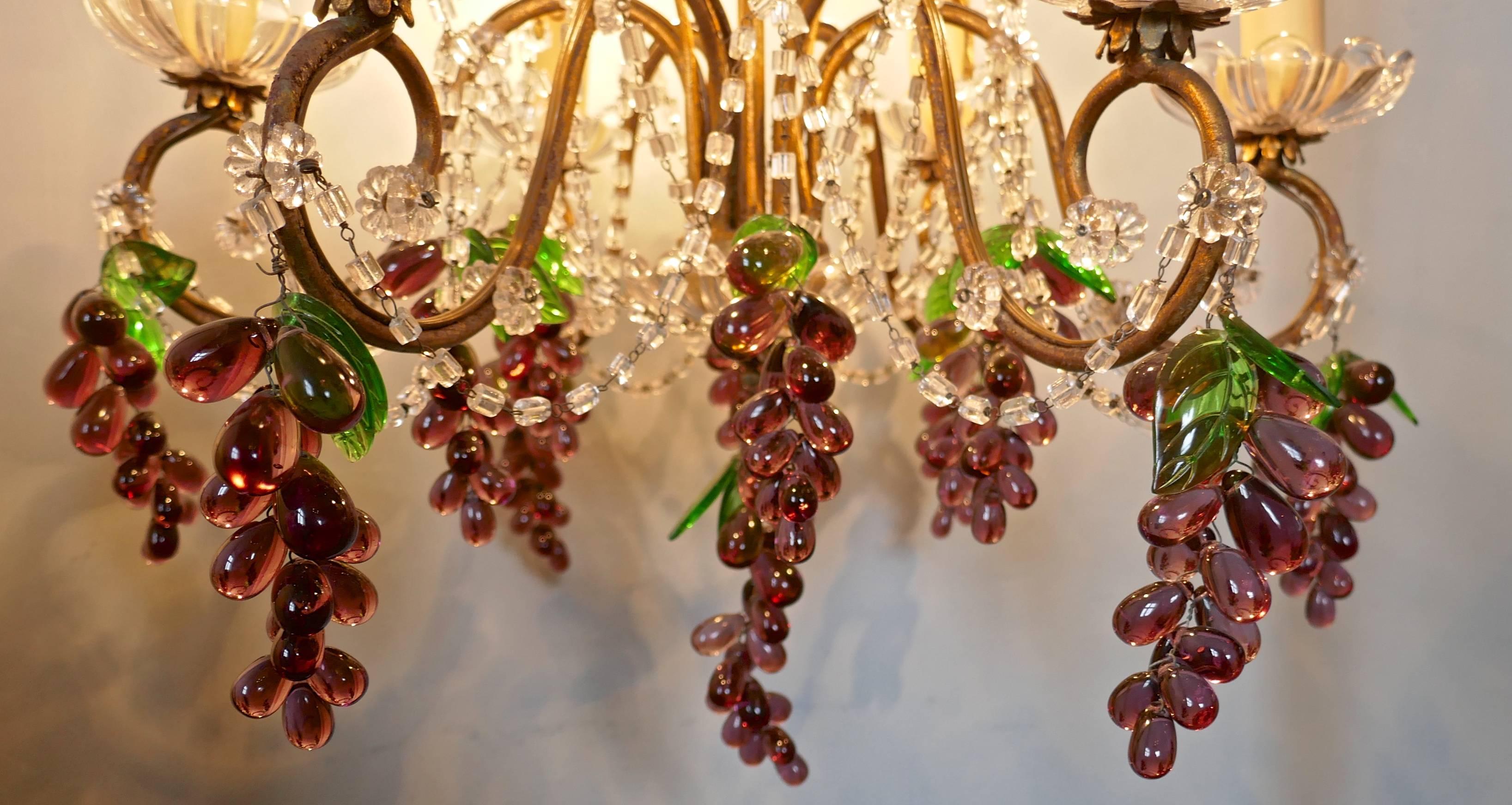 Large six branch chandelier hung with amethyst grapes

This is a stunning piece, the gilded frame is hung with bunches of amethyst grapes, the bunches are small at the top of the light but get larger as we work down to the bottom, each bunch has a