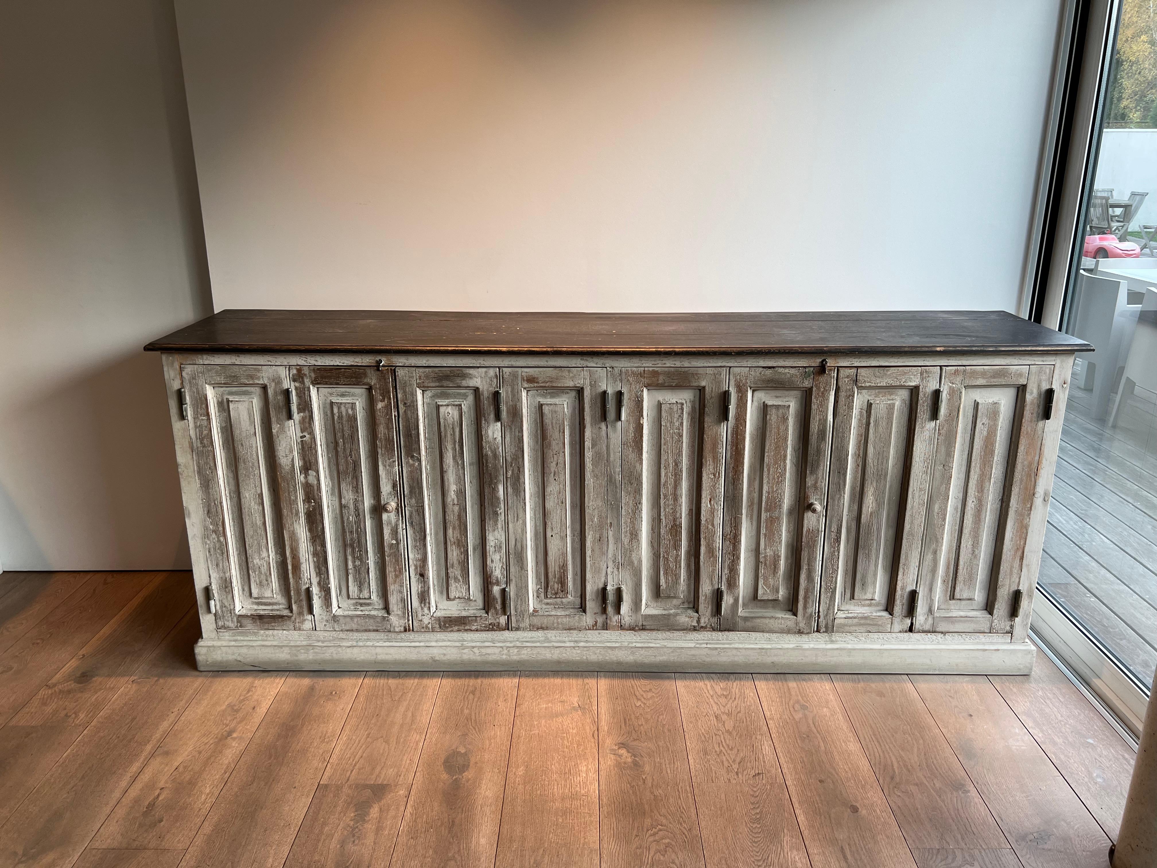 This nice and decorative large 6 doors cupboard is made with old patinated shutters and oak elements. This is the perfect piece for vaissel, barware, clothing, linens... This is a French work.