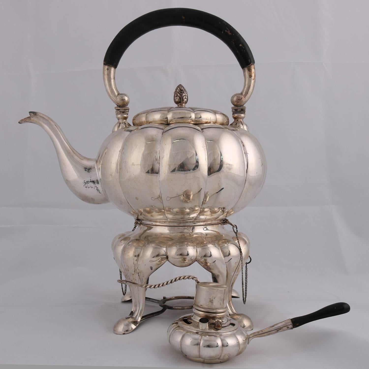 Large French six-piece .800 silver tea set features gadrooned or lobed melon form with fleur de lis form feet; includes tea pot, warmer, coffee pot, milk, creamer, covered sugar and tray, marked .800, 219.0 toz, circa 1900

Measures: tray 32