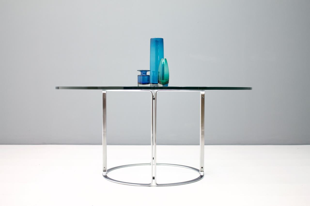 Large dining table glass top and steel base. Designed Horst Brüning, Germany for Kill International, 1970s.
Measures: Diameter 150 cm, high 71 cm.
Very good condition!


Horst Brüning:
The Hamburg interior architect and industrial designer developed