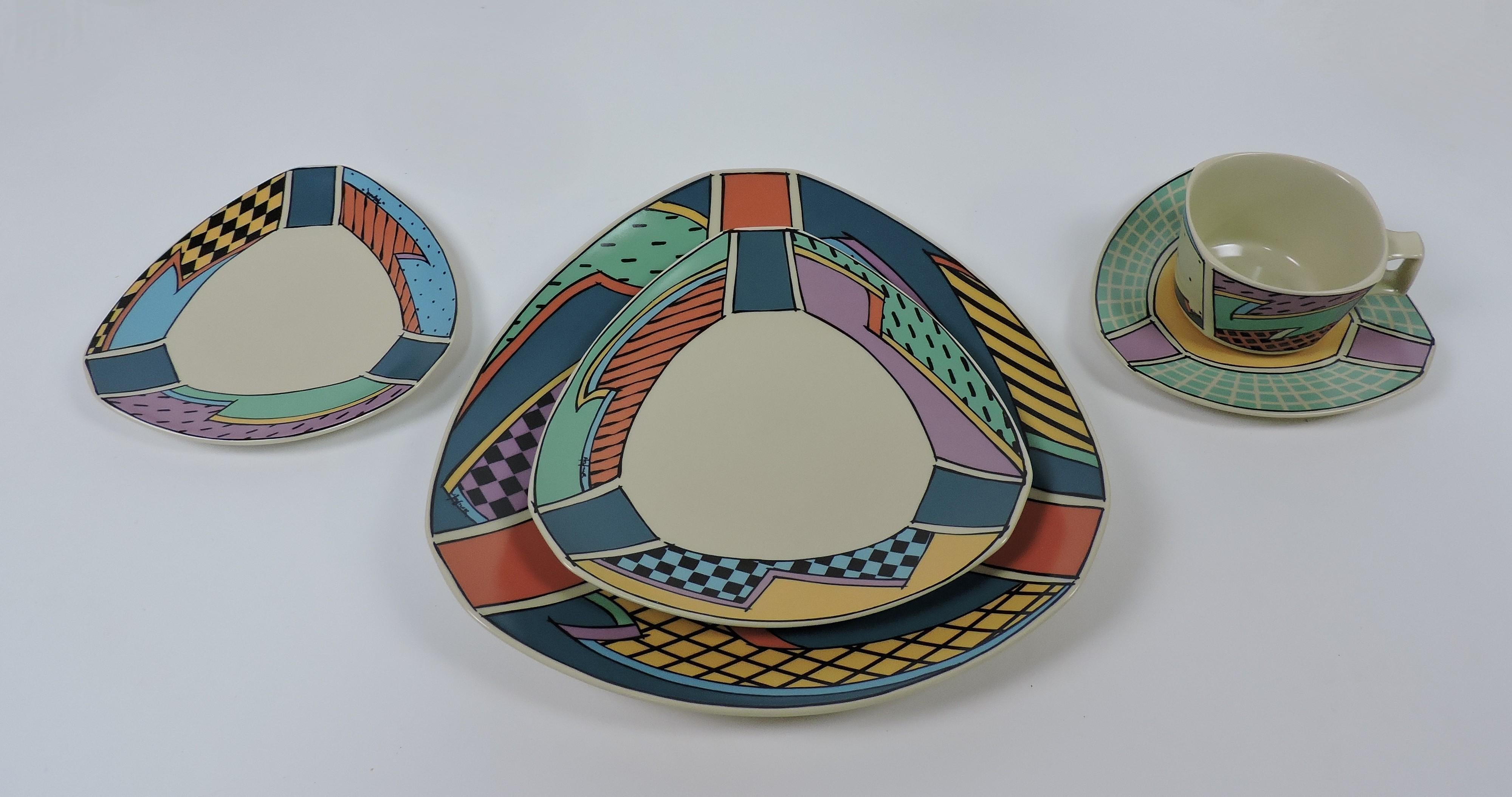 Large set of Memphis style Flash series porcelain dinnerware for twelve designed in 1982 by noted American ceramist and glass artist, Dorothy Hafner, and manufactured in Germany by Rosenthal. This iconic set has an exuberant pattern of dots, checks,