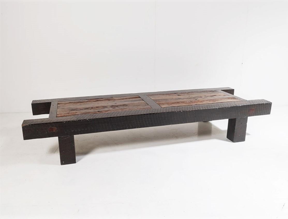 A large chunky Burmese teak coffee table of distinct character. Burmese teak has a rich dark quality that is extremely difficult to mimic, the colour and tone of this piece is superb with the deep rich tone of the frame contrasting with the lighter