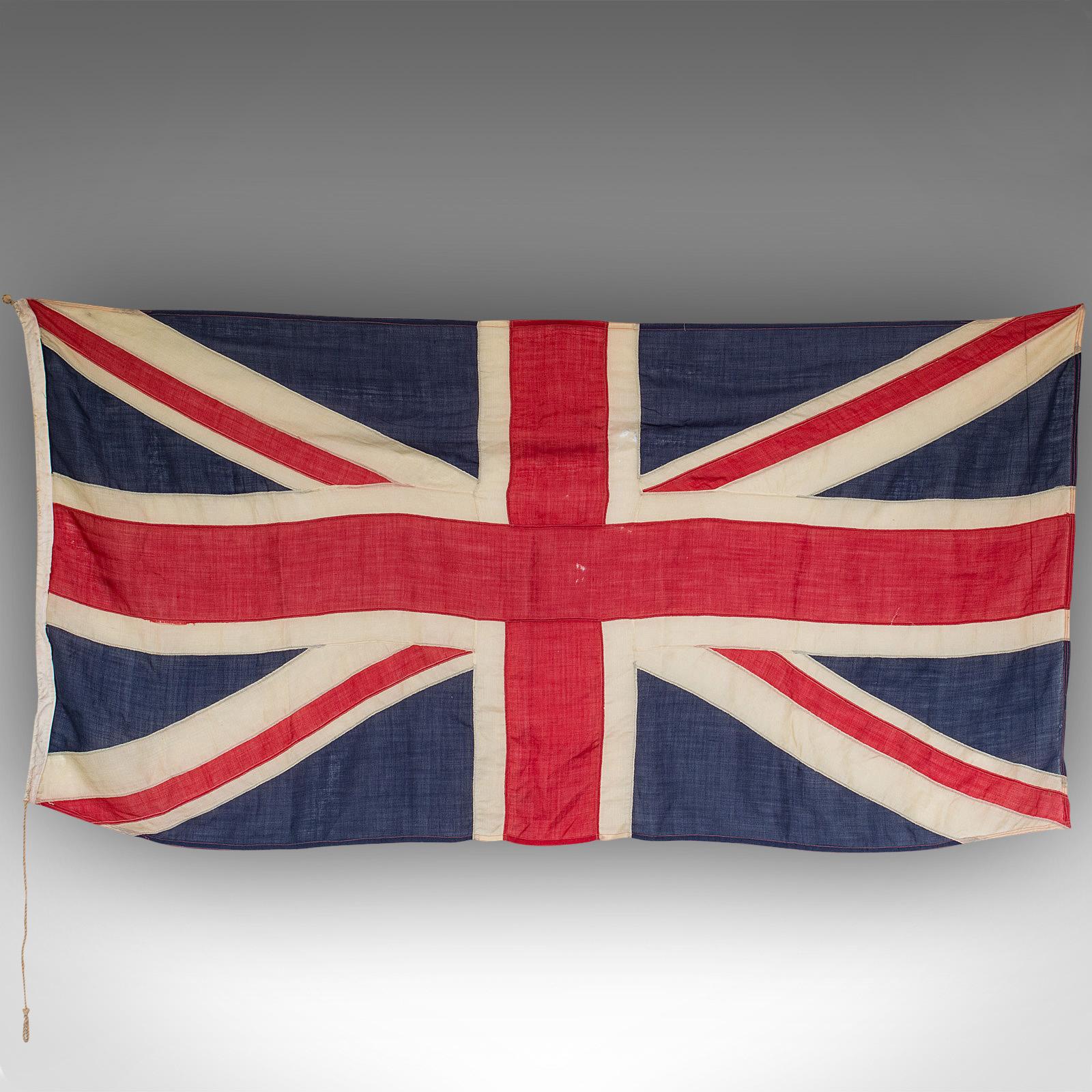 This is a large, vintage Union Jack. An English, cotton flag of the United Kingdom of Great Britain, dating to the mid-20th century, circa 1945.

Ready to fly, vintage flag
Displays a desirable aged patina
Quality stitch seam flag with