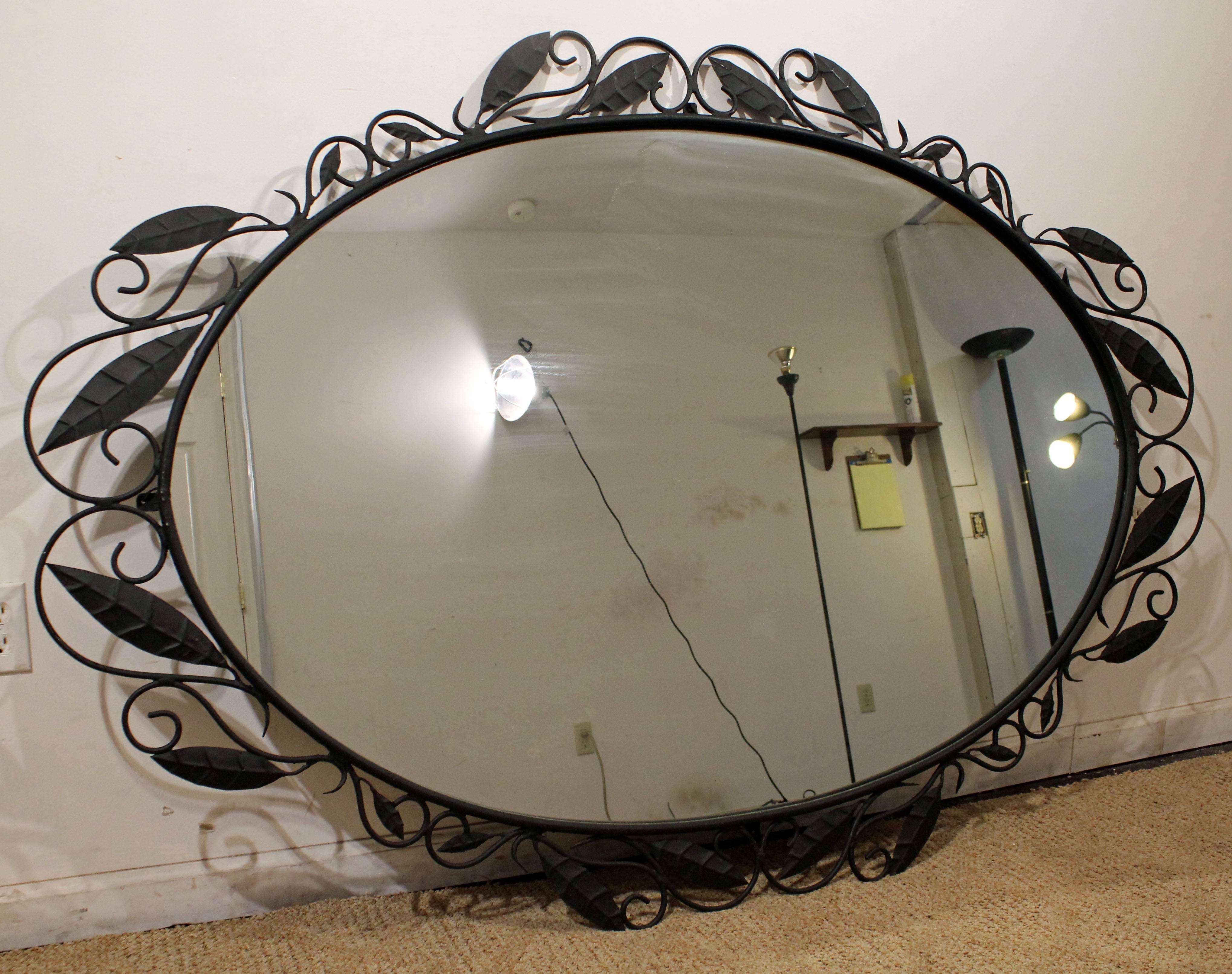Offered is a large oversized Italian wrought iron mirror. This mirror is made of wrought iron. It is in great condition, showing minor wear (minor paint chips on iron, age wear-see pics). It is not signed.

Dimensions: 48' x 70