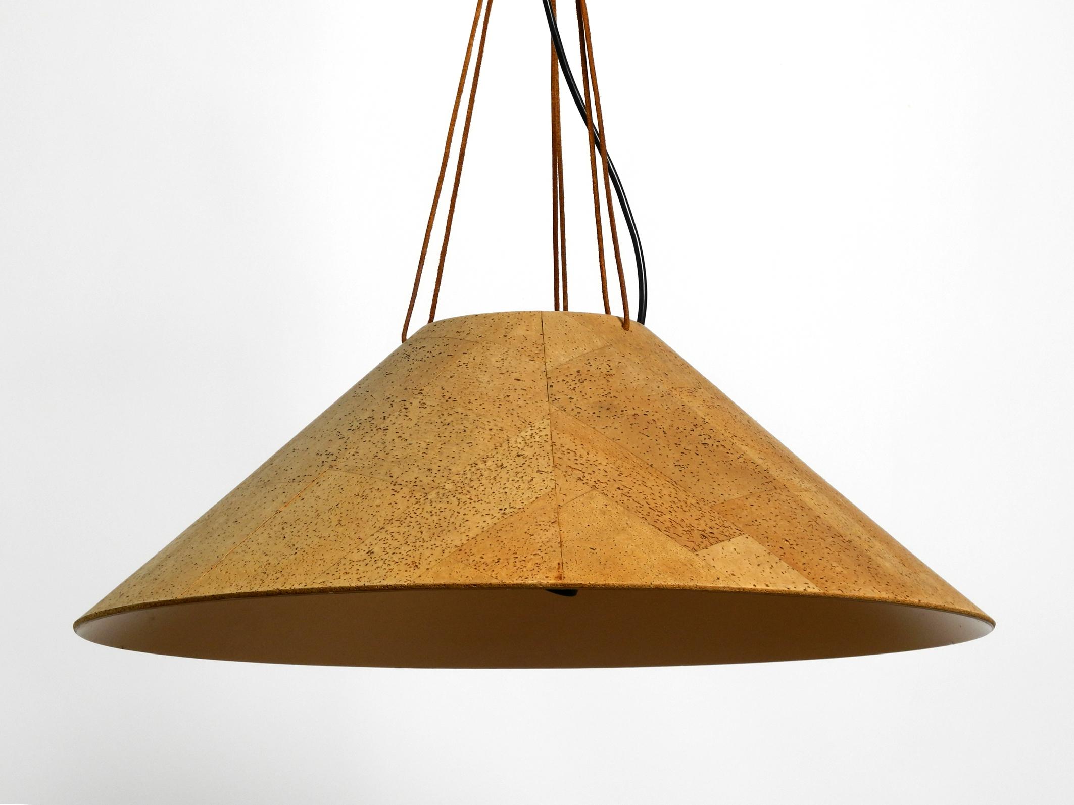 Very rare large 1970s original cork hanging lamp from M-Design.
Designed by Wilhelm Zanoth and Ingo Maurer. Made in Germany.
Beautiful classic design. In very good original condition.
The round shade is made of aluminum on the outside with a cork